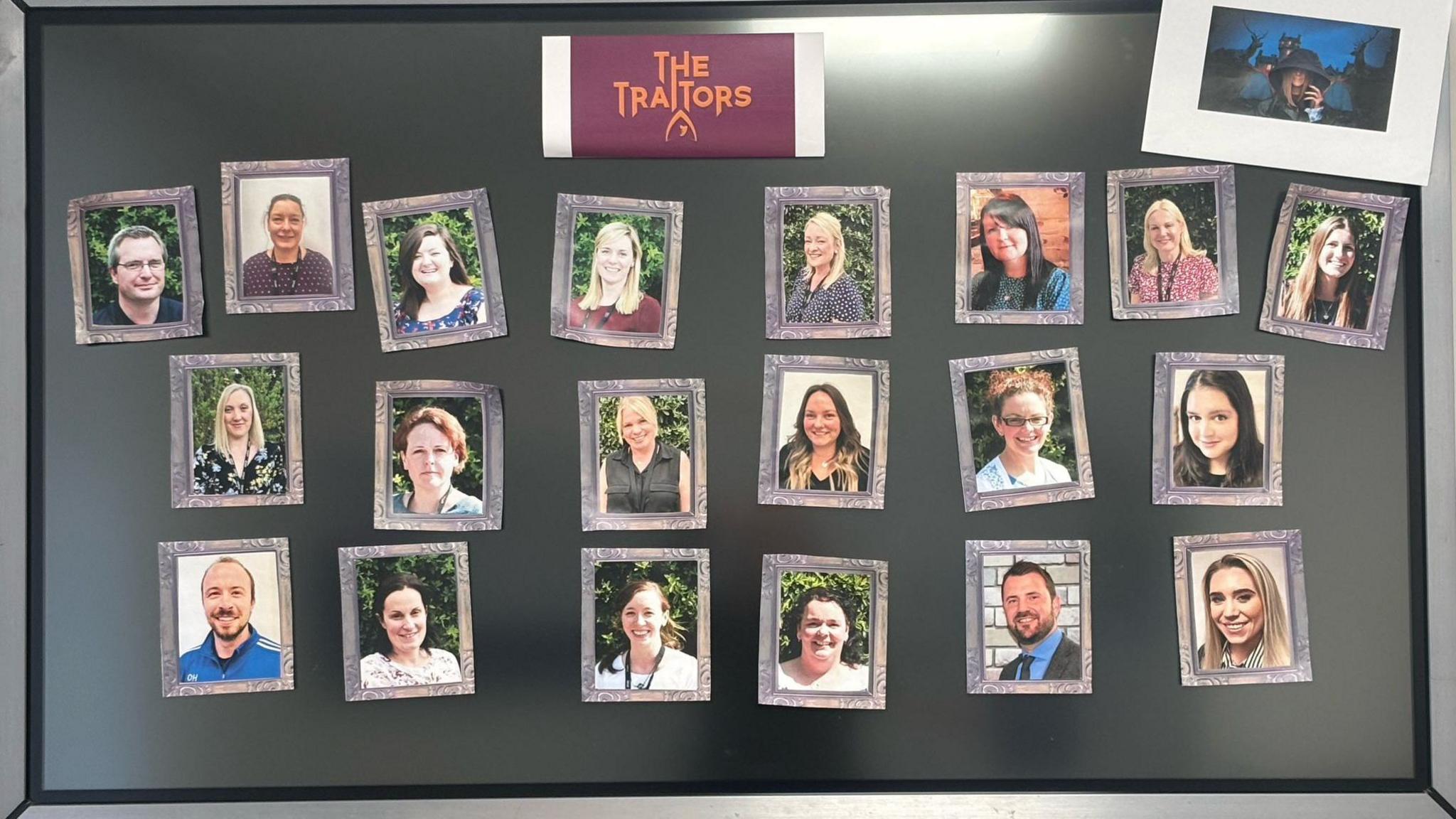 A black board with 21 photos of teachers stuck on.