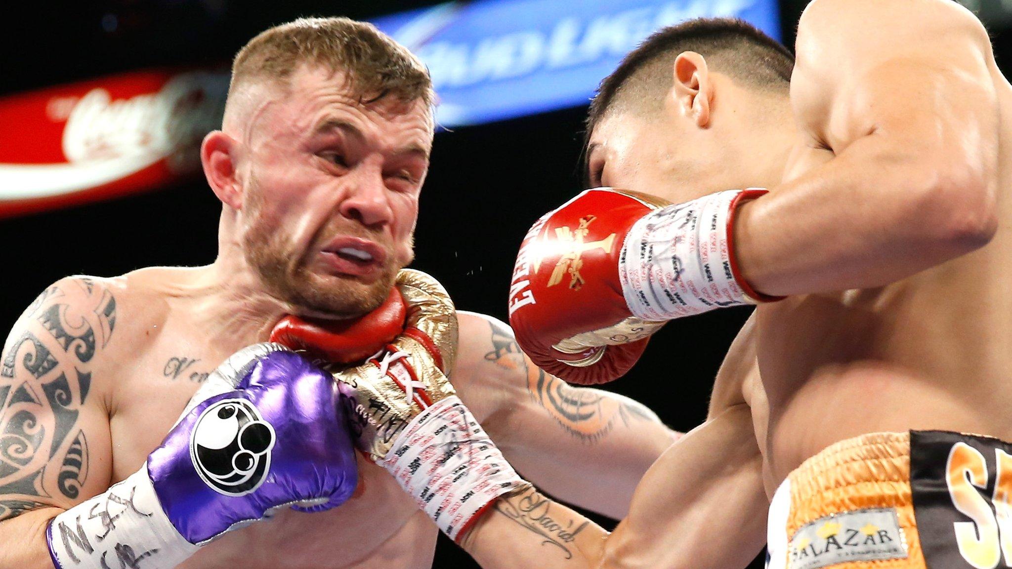 Carl Frampton feels the force of a punch from Leo Santa Cruz