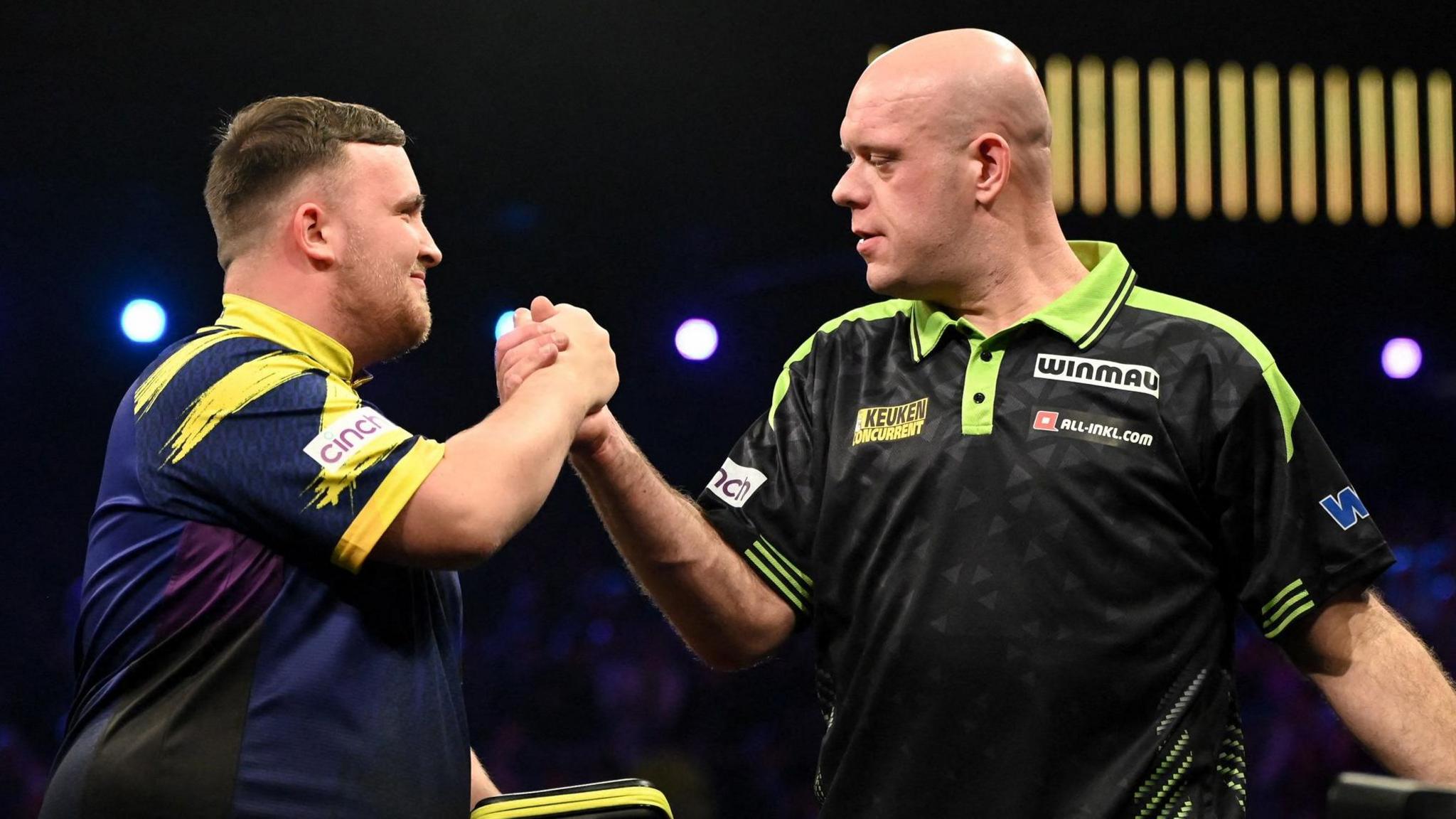 Luke Littler and Michael van Gerwen clasp hands