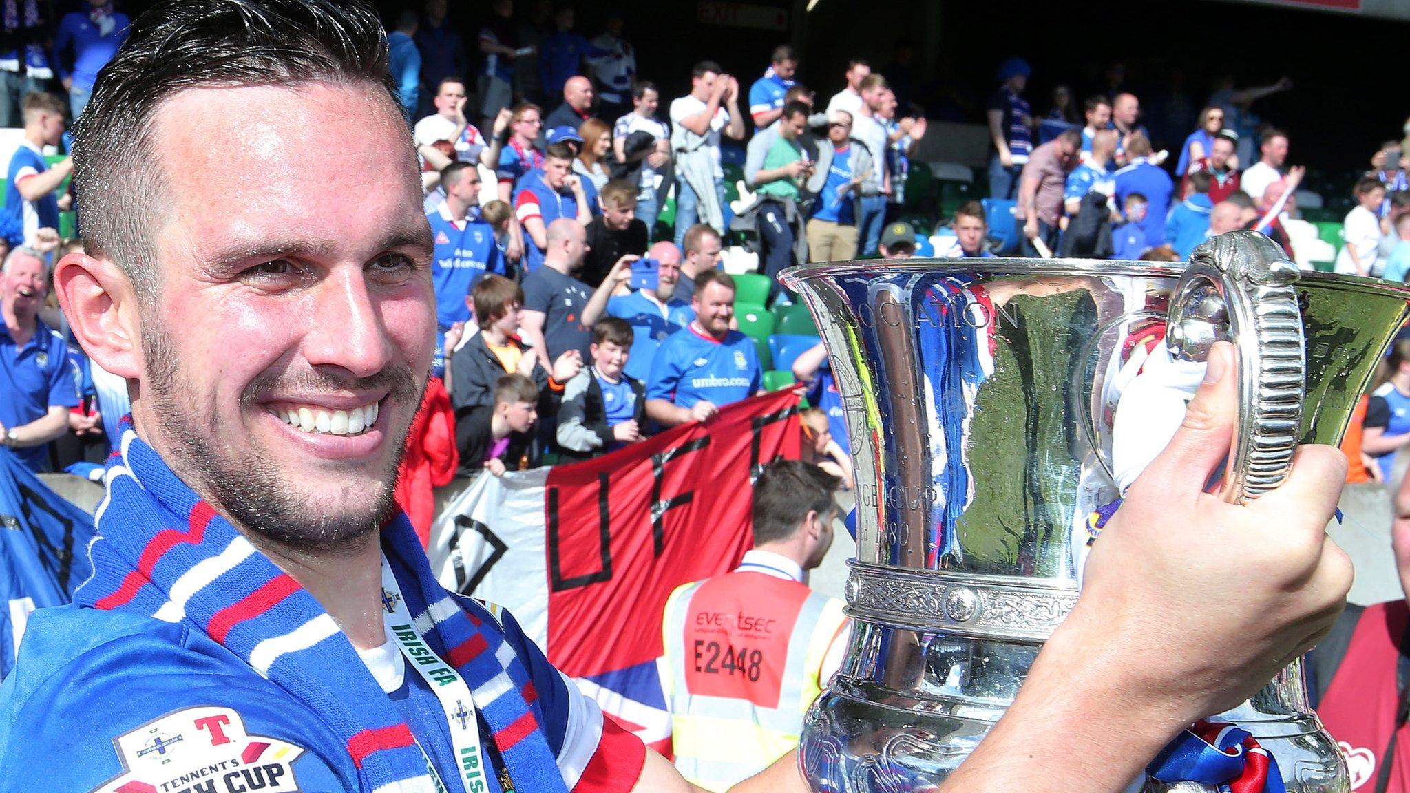 Andrew Waterworth celebrates with the Irish Cup after his hat-trick against Coleraine in the final