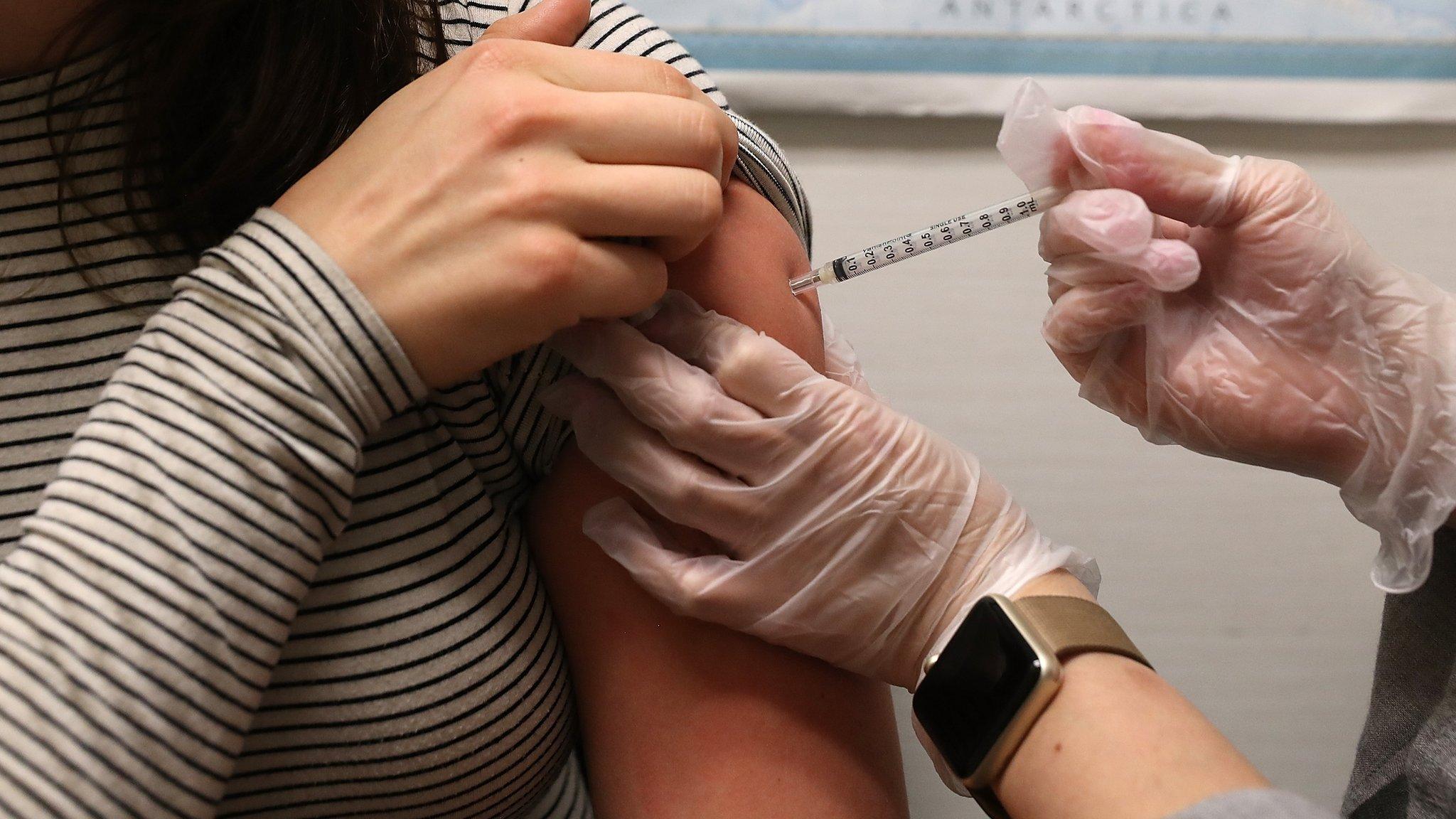 A woman receives a flu shot at a pharmacy in San Francisco, California