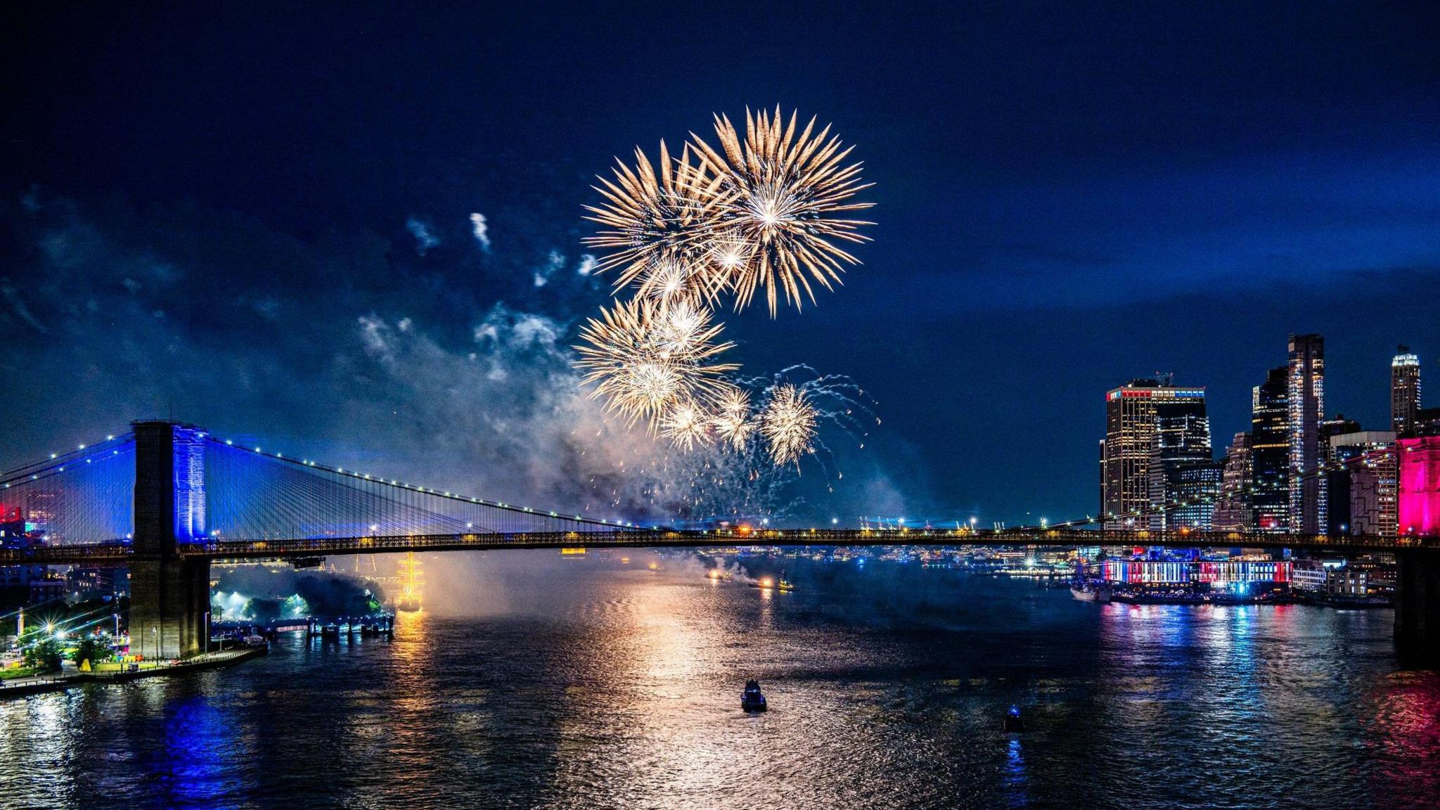 Fireworks light up the sky over the Brooklyn Bridge during a fireworks display marking the 250th anniversary of US independence in New York, New York