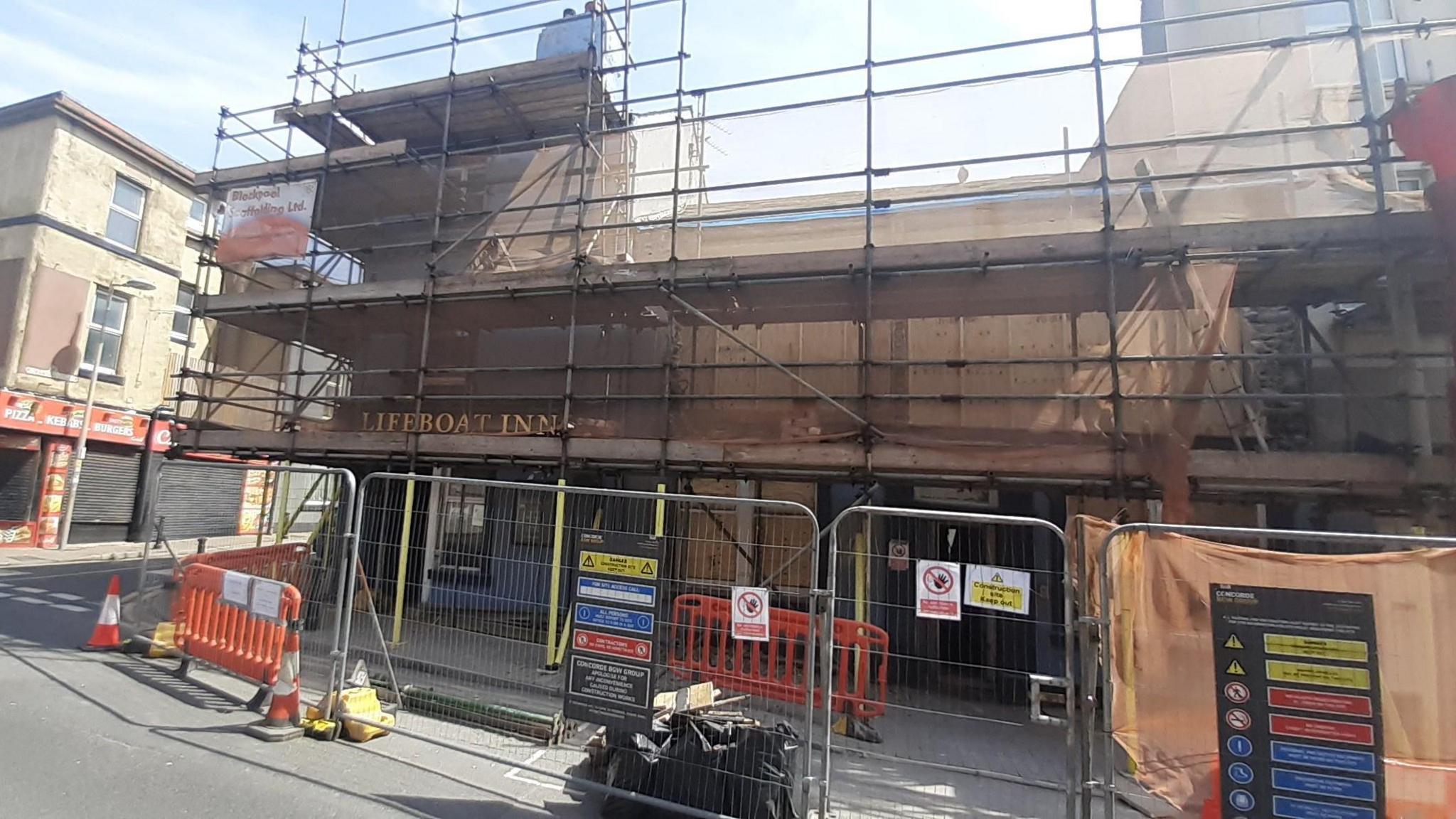 The Lifeboat Inn surrounded by scaffolding.