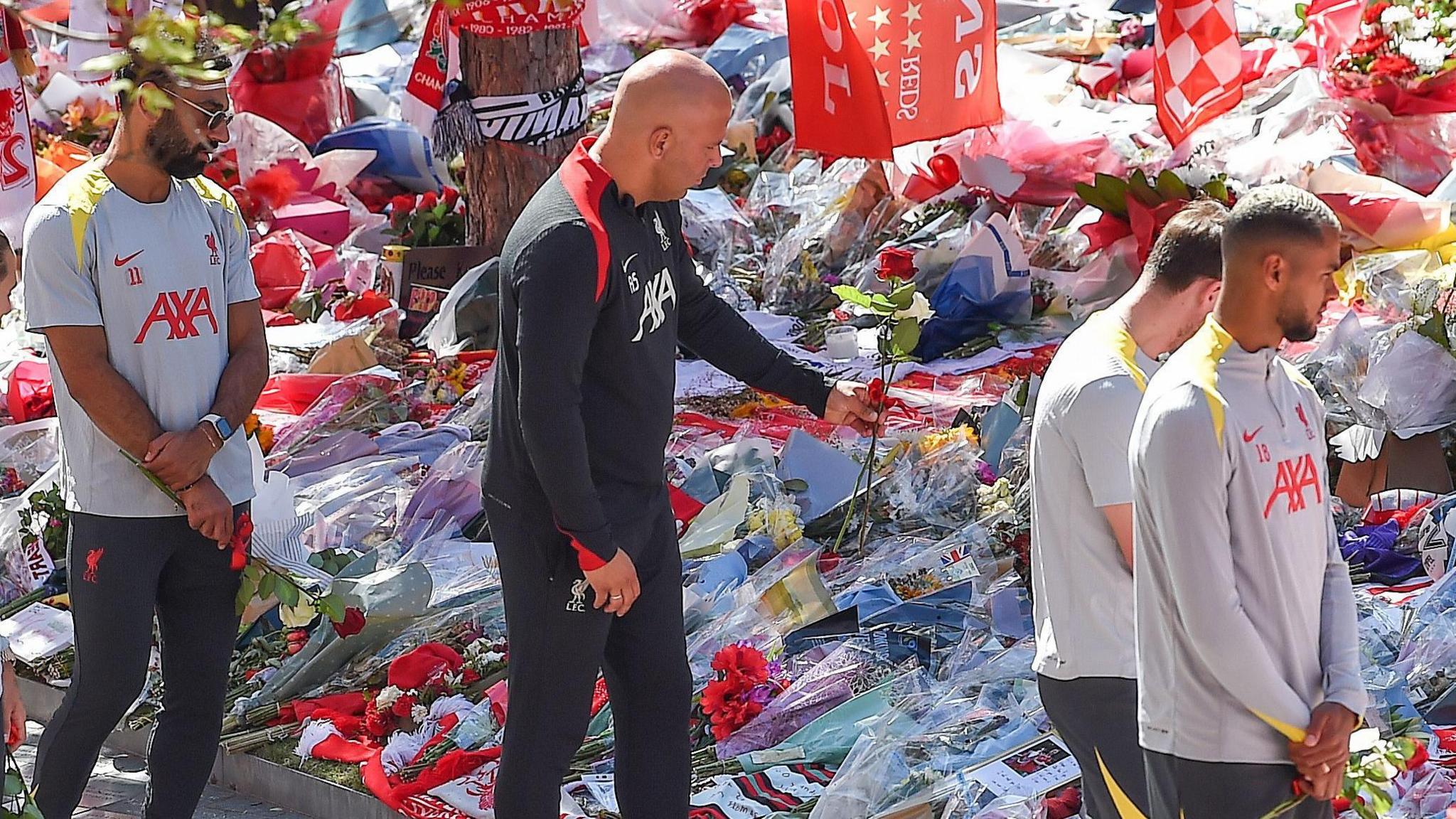 Liverpool manager Arne Slot and his players put some flowers down for Jota and his brother Andre Silva at Anfield