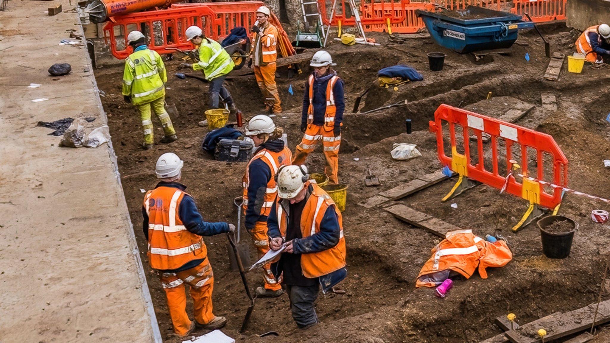 The archaeological team from Oxford Archaeology excavating pits on site in the east wing of the new basement