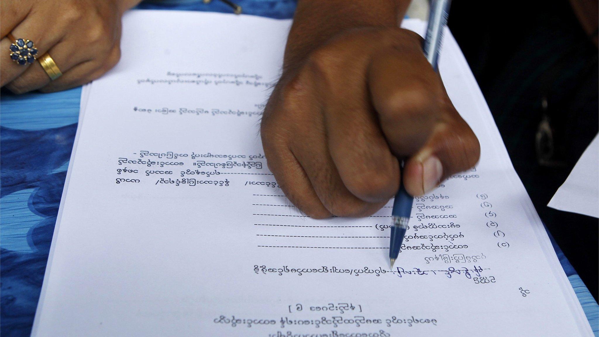 A person fills out their voter registration form in preparation for upcoming general elections, in Mandalay, Myanmar, 08 July 2015