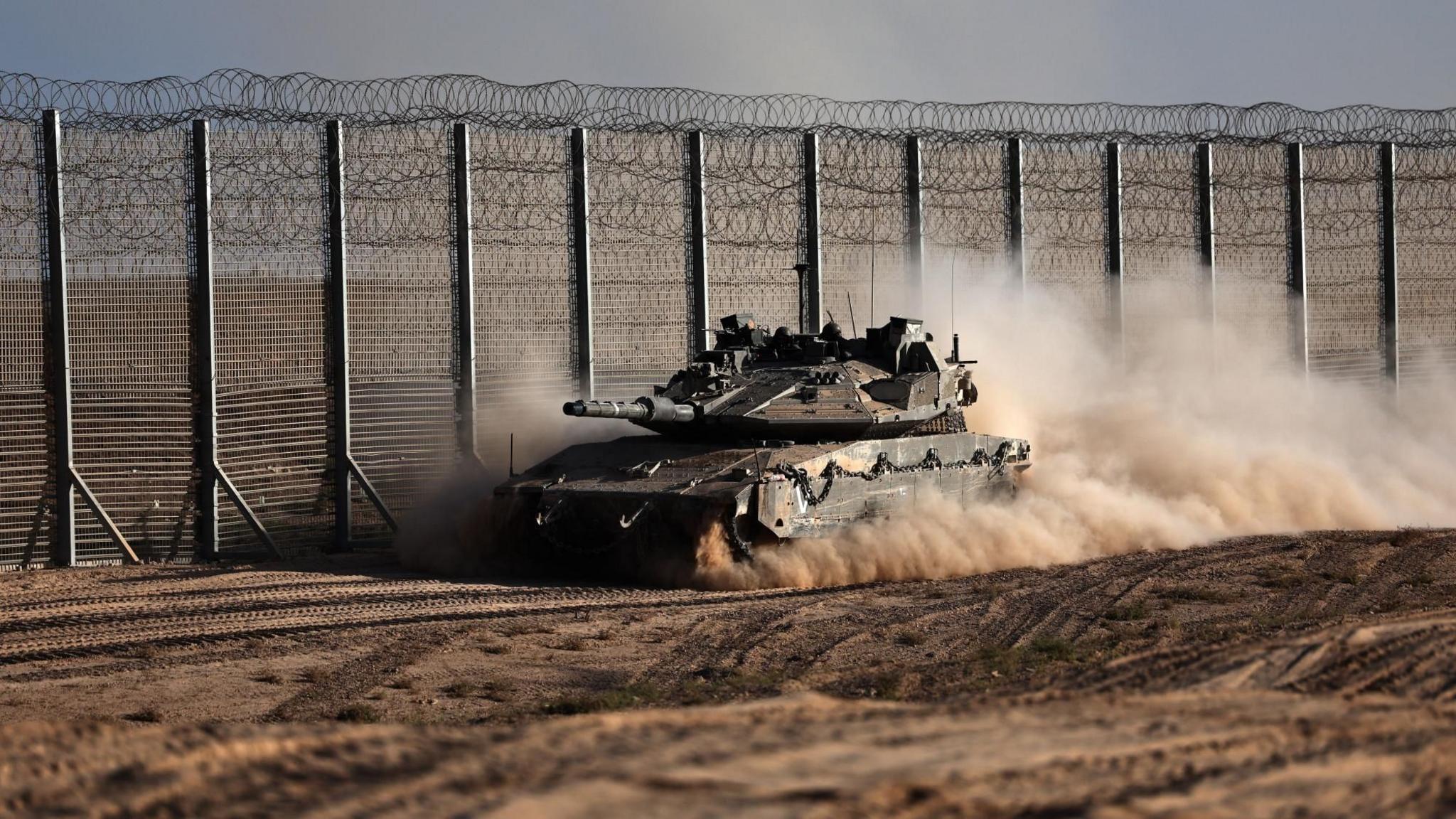 An Israeli tank manoeuvres near the Israeli border with the Gaza Strip, in southern Israel (21 October 2025)
