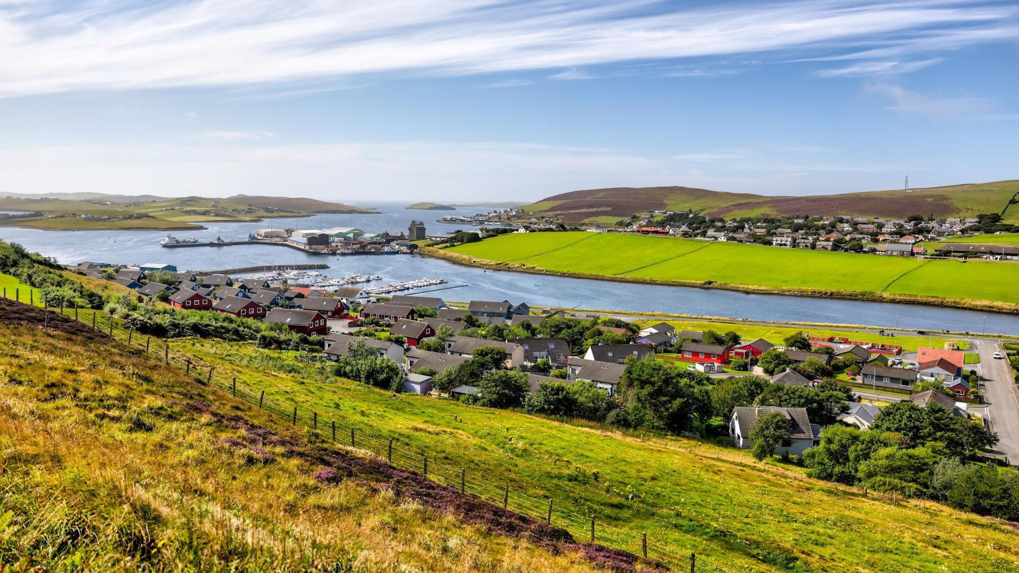 Houses along a sea loch in Scalloway, Shetland.