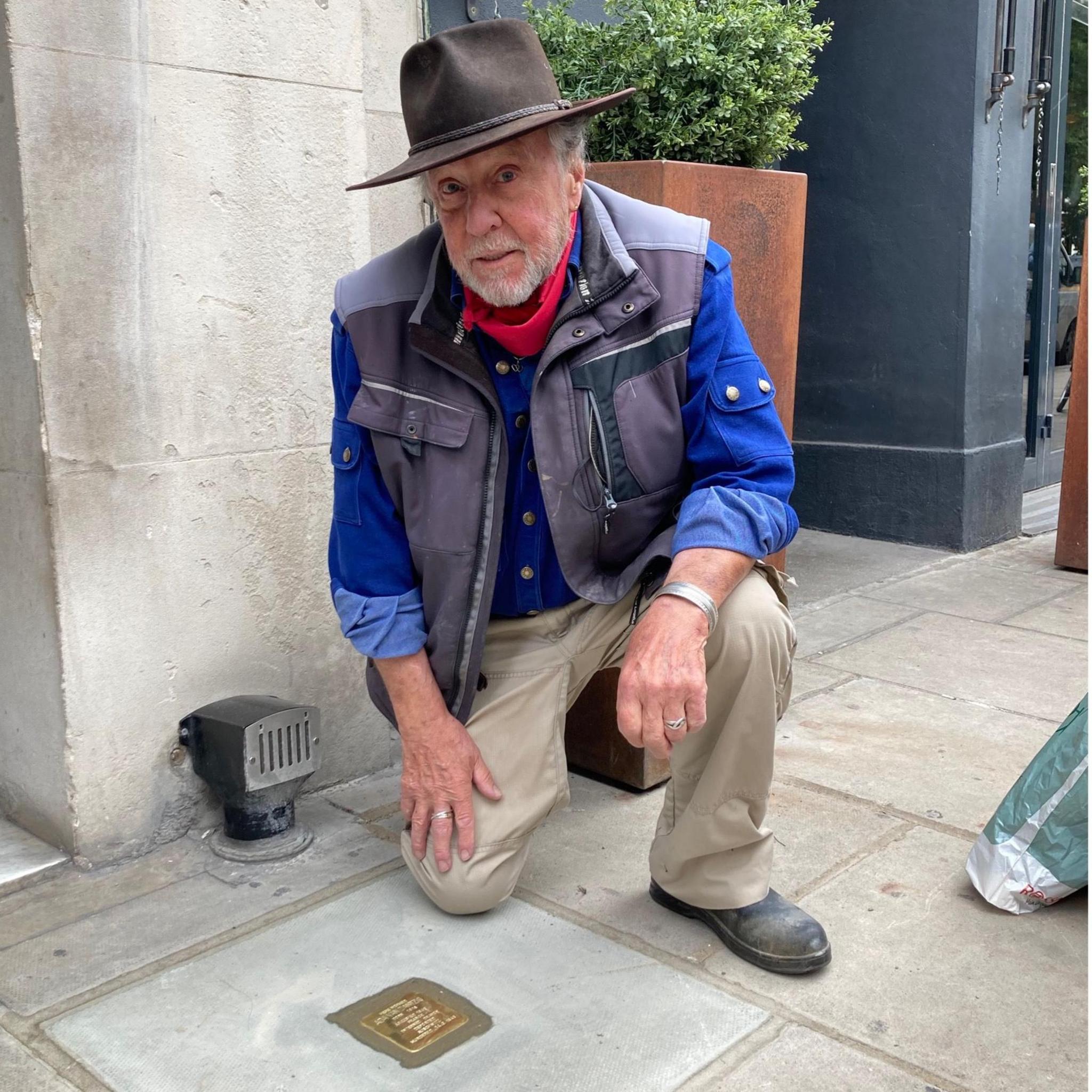 Gunter Demnig with an example of a Stolperstein