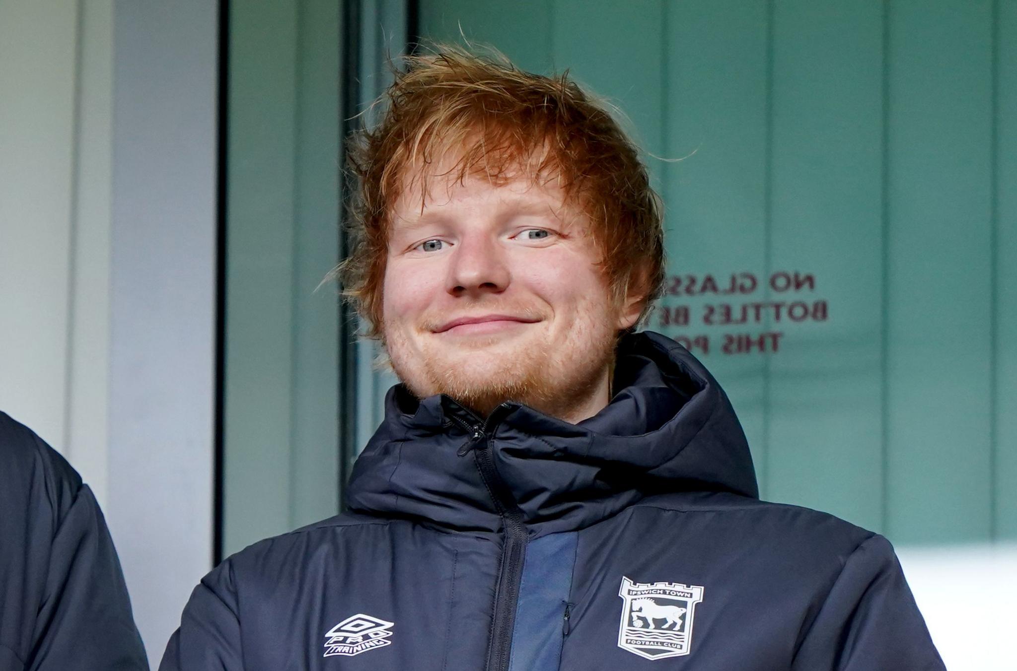 Ed Sheeran wearing an Ipswich Town jacket