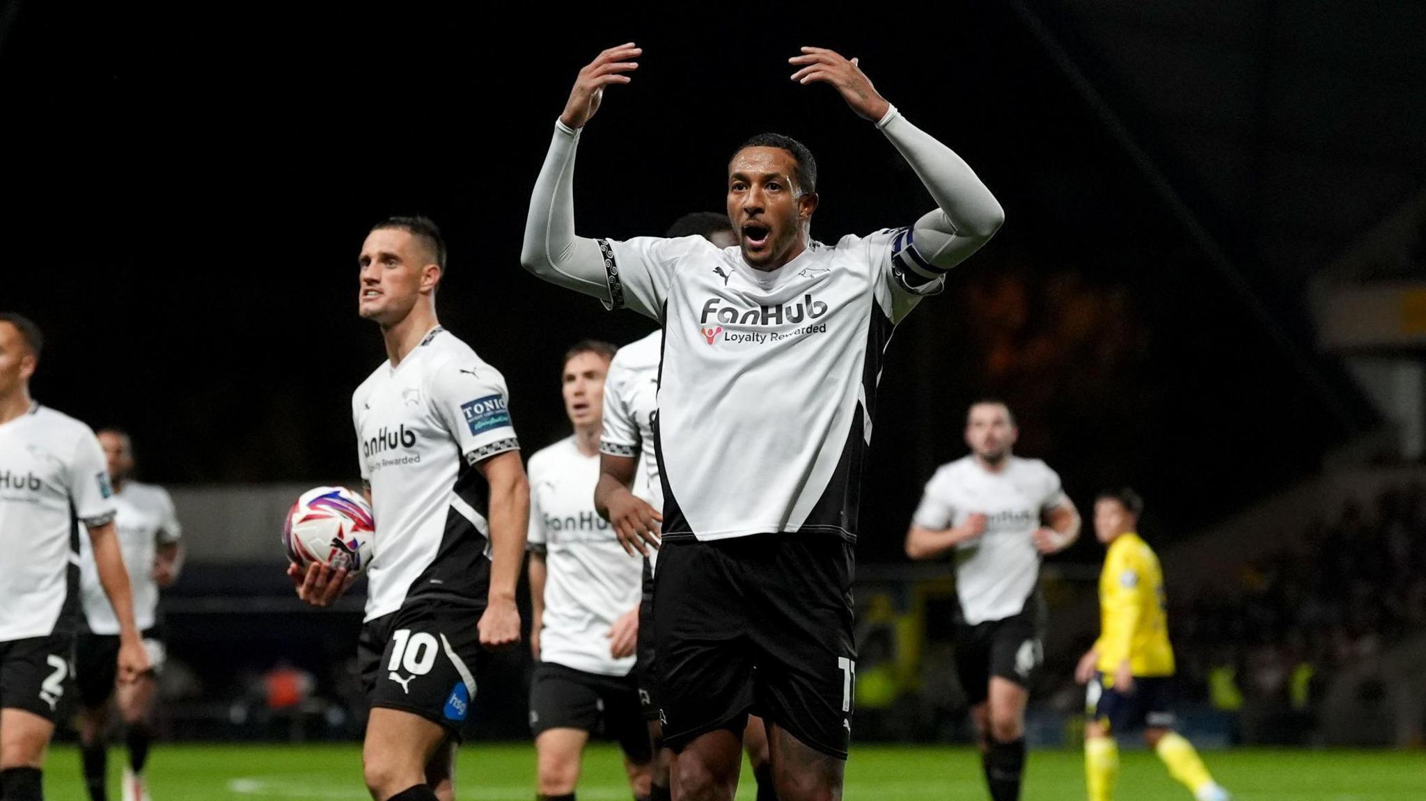 Derby County forward Nathaniel Mendez Laing scores and celebrates for his side away at Oxford United