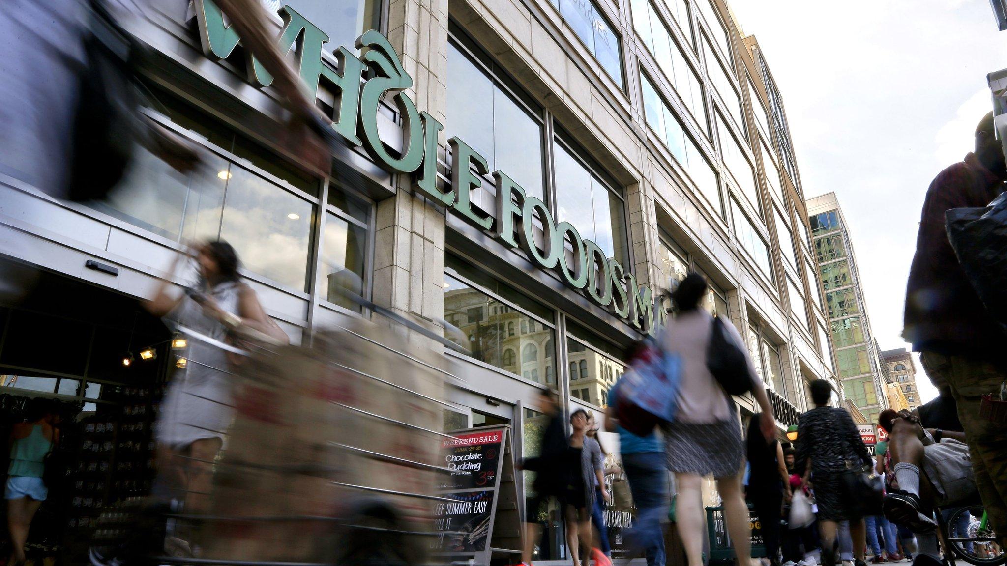 Exterior of a Whole Foods Market store with passers by