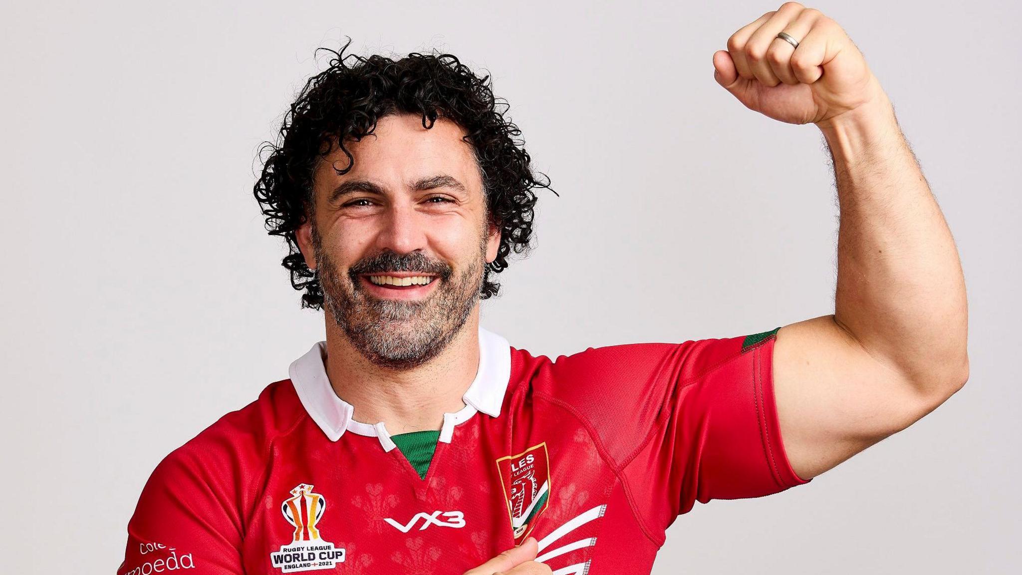 Rhys Williams poses for a photo in a Wales shirt