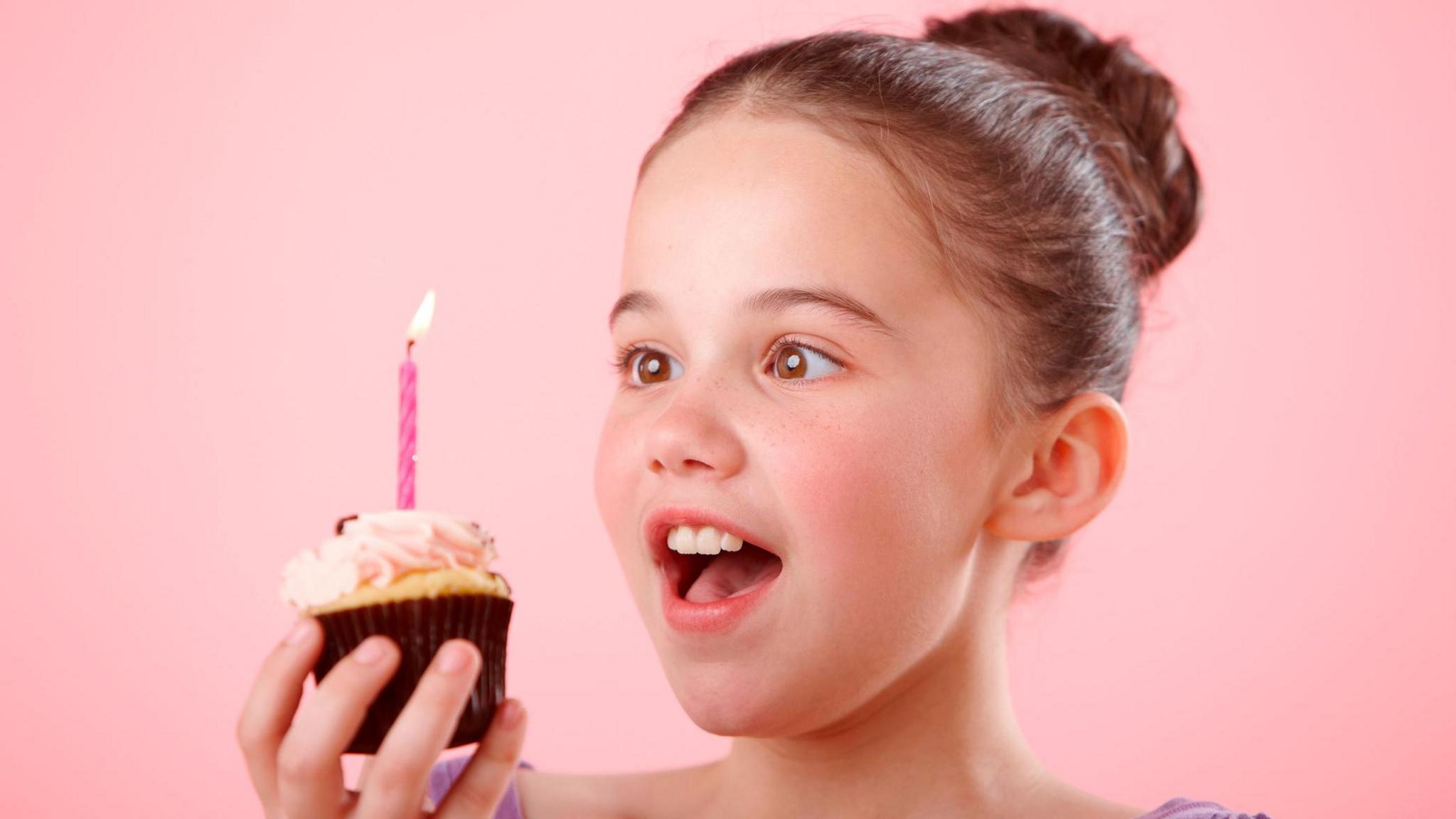 Girl with birthday cupcake 