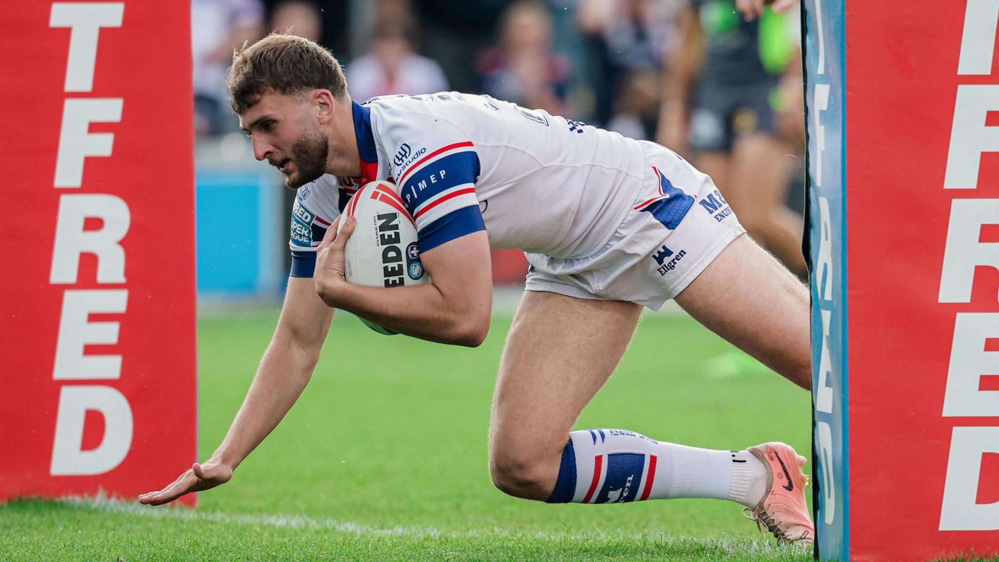 Josh Rourke diving in between the posts to score a try for Wakefield