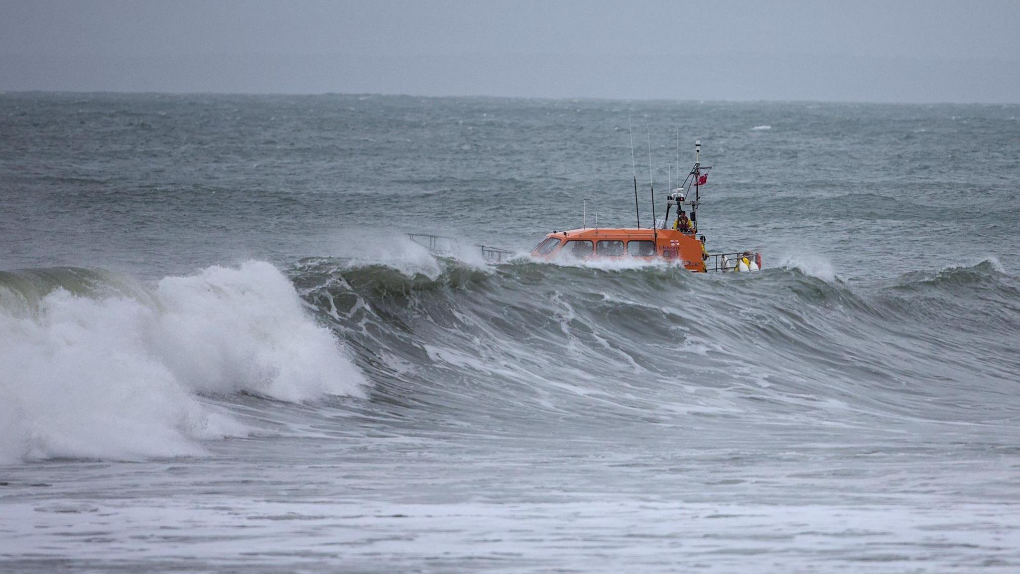 An RNLI all weather lifeboat in rough seas off of the coast of Lynmouth, in Devon