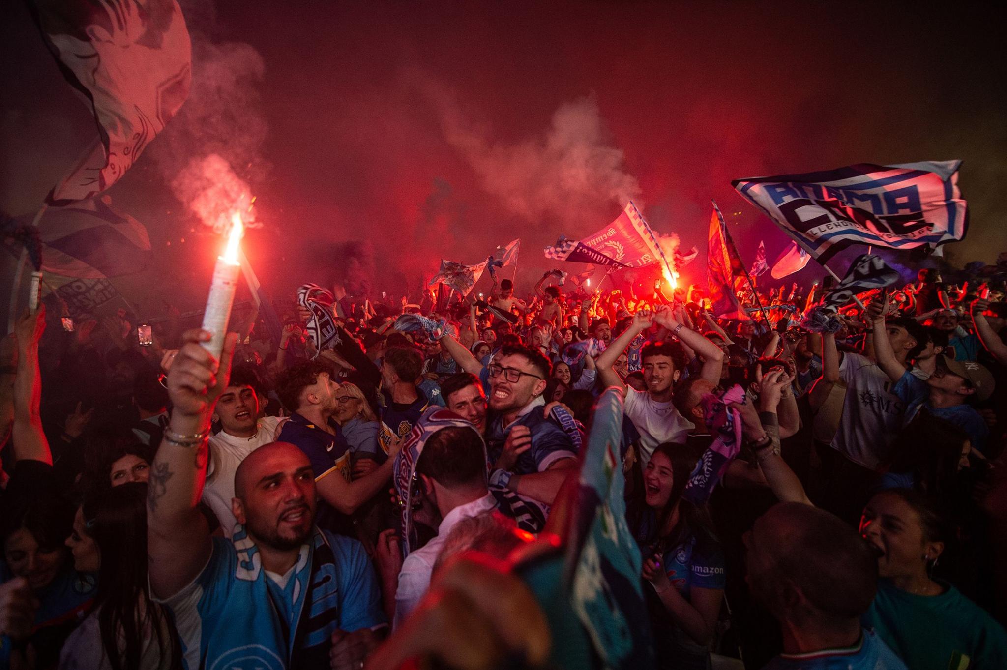 SSC Napoli supporters celebrate the victory of the fourth Scudetto after watching the last Serie A match between Napoli and Cagliari on the big screen in Piazza Plebiscito in Naples, Italy. Photo by Ivan Romano