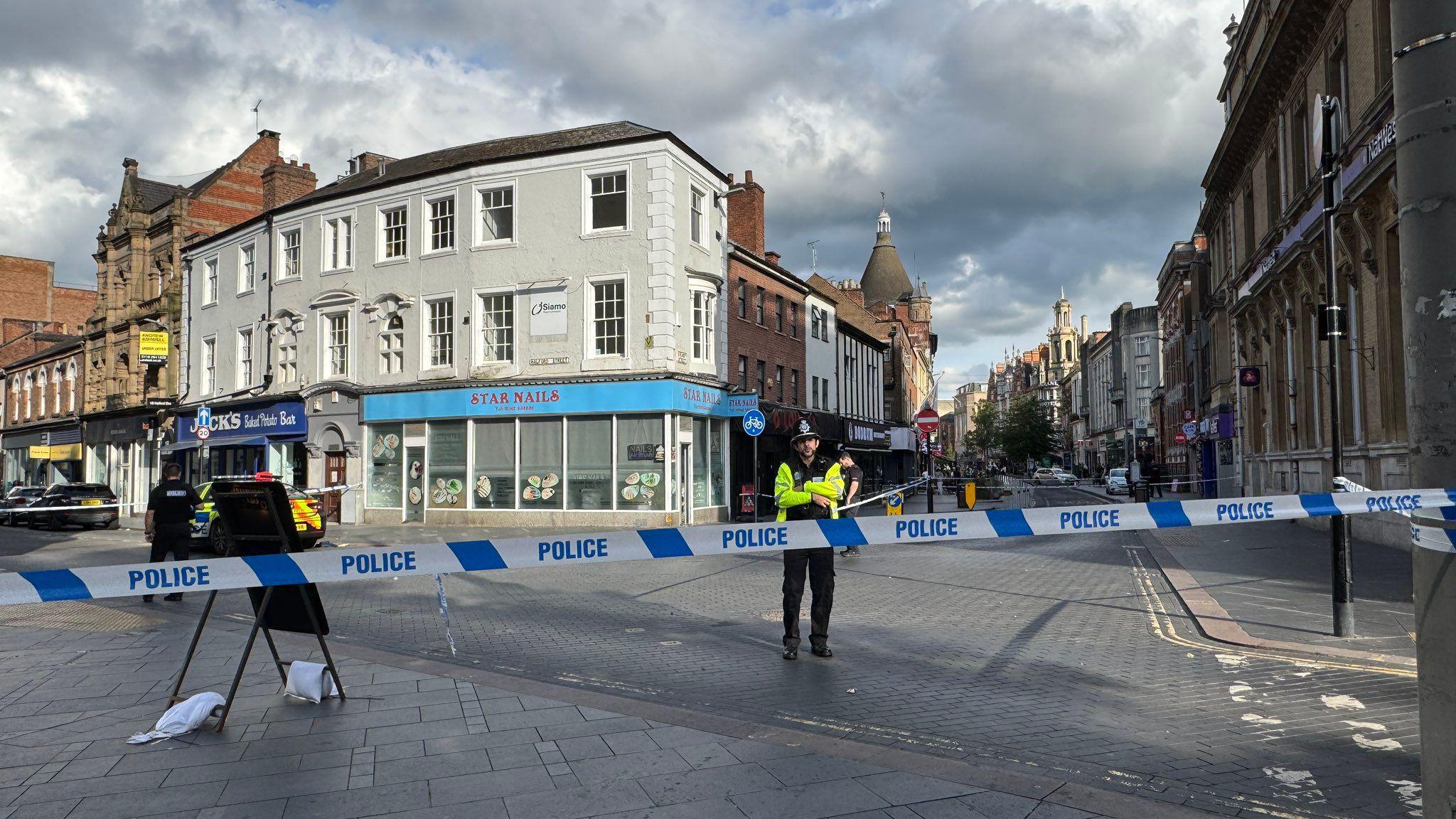 A police officer inside a cordon in Leicester city centre