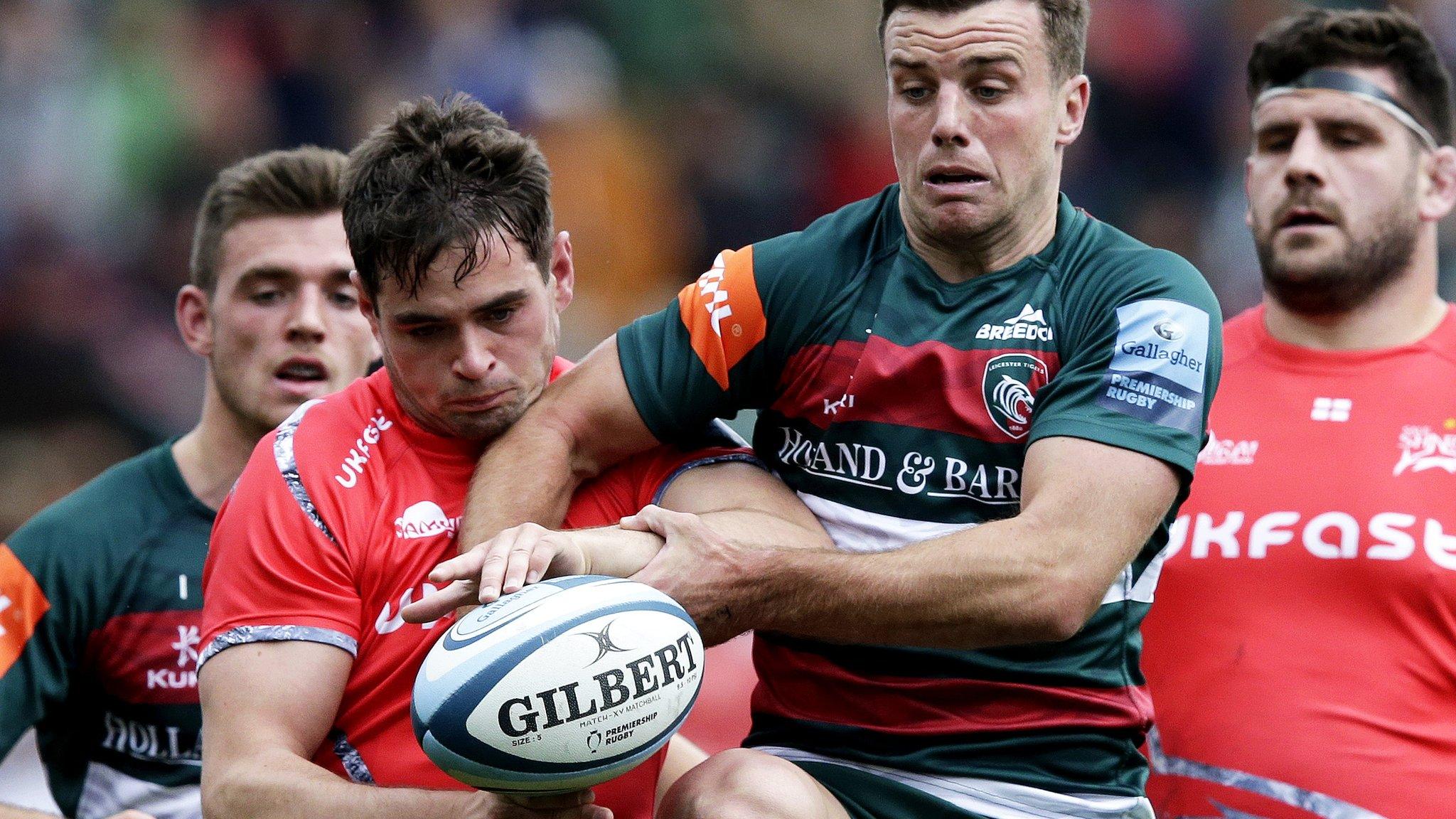 Sale's Luke James and Leicester's George Ford compete for the ball