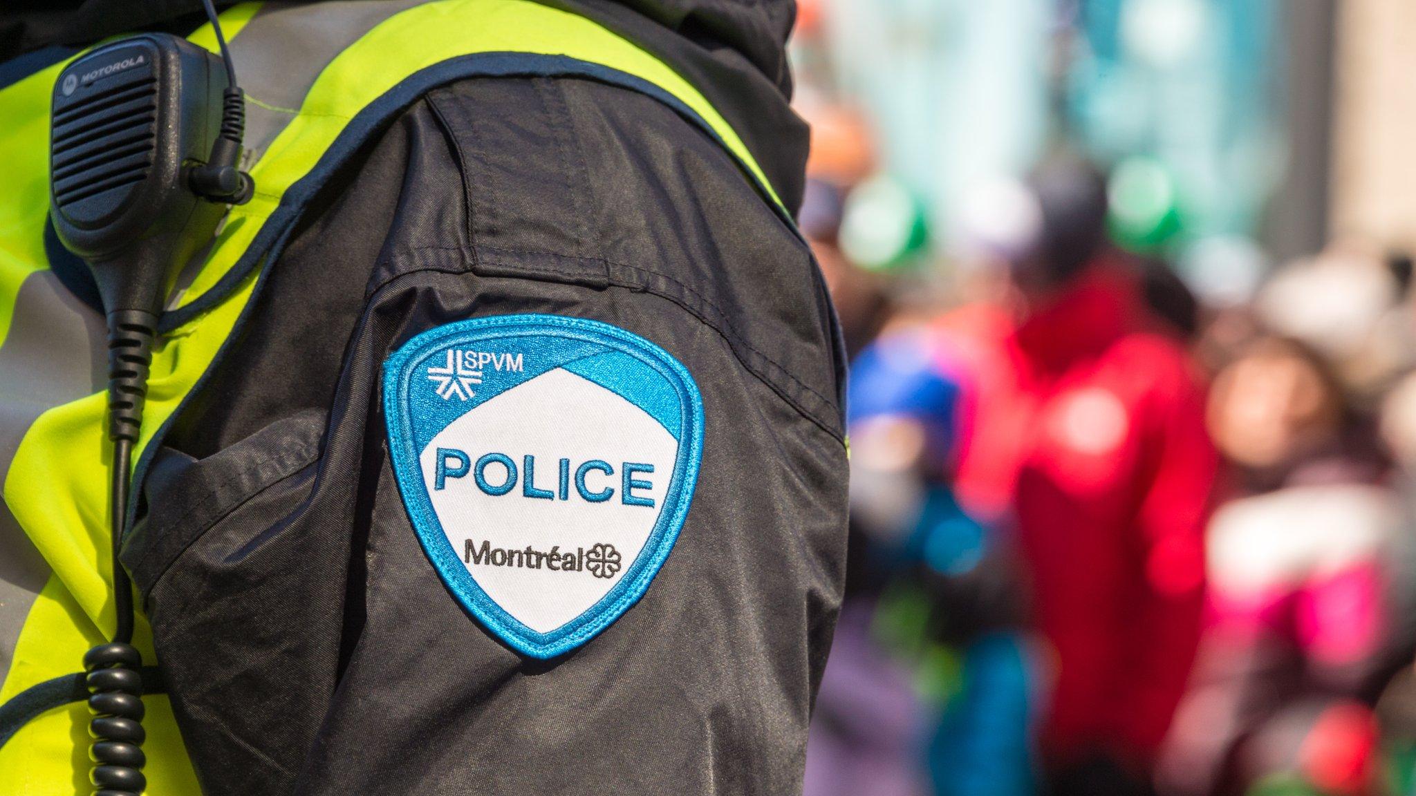 Montreal, Canada - 19 March 2017: Close-up of a police patch with crowd n the background