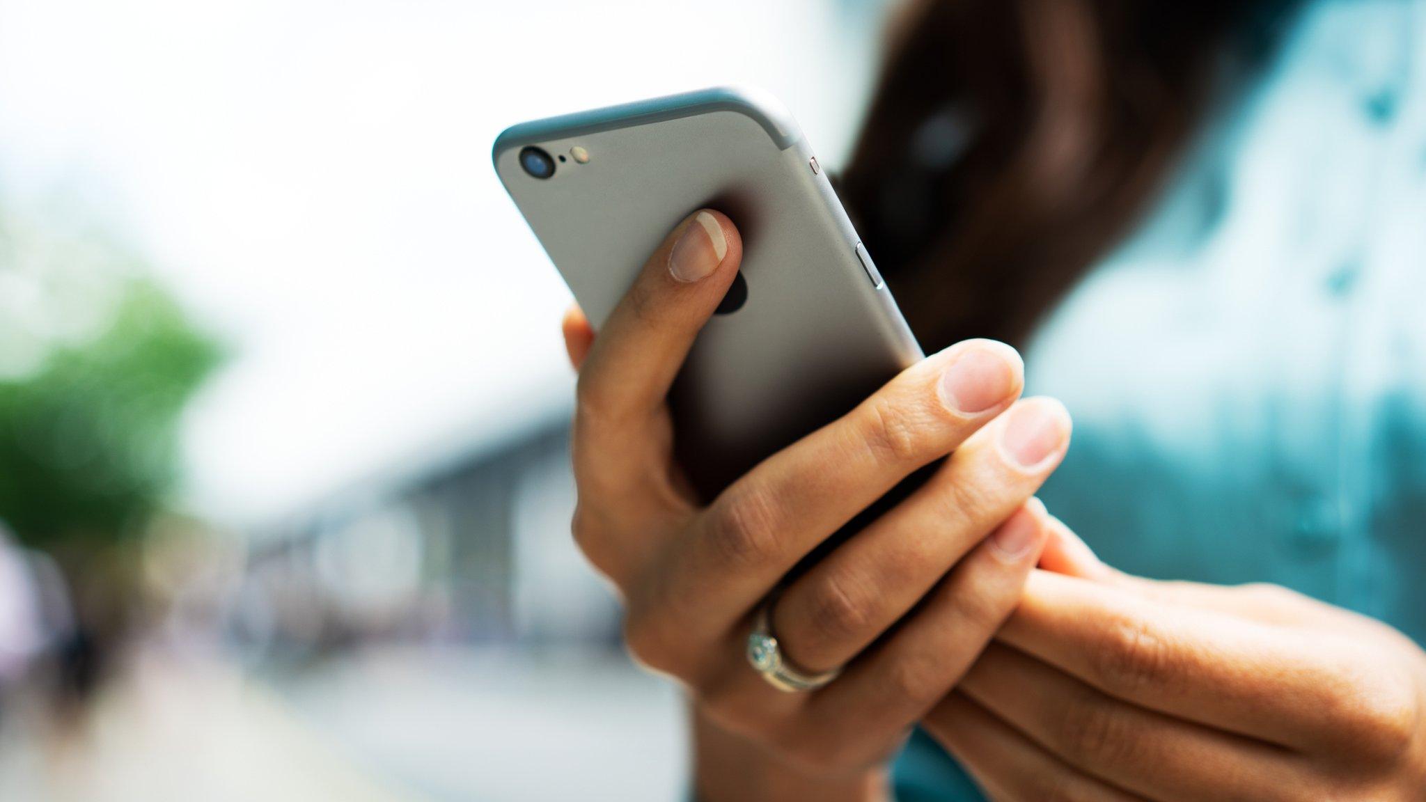 A woman holding a phone