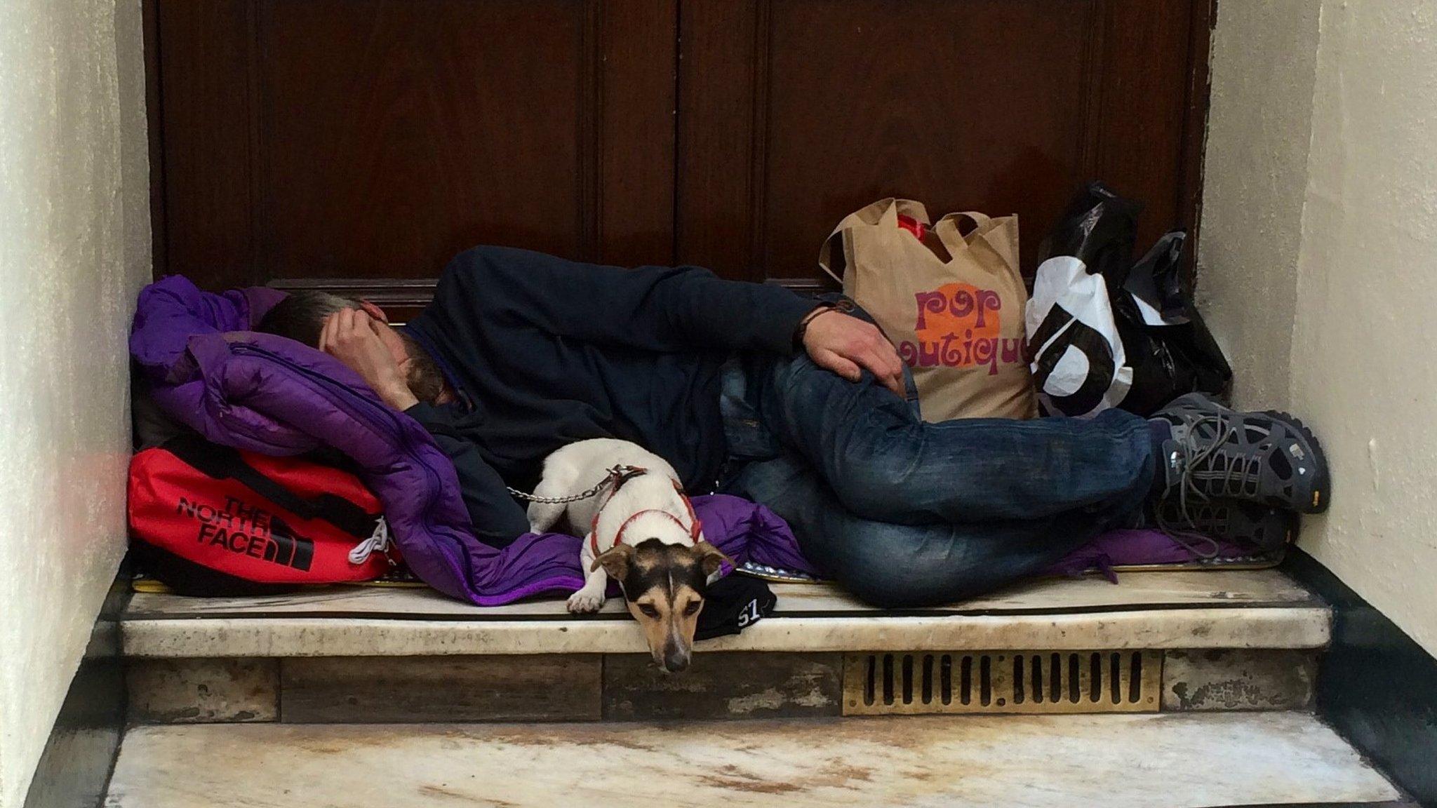 A man sleeping in a doorway