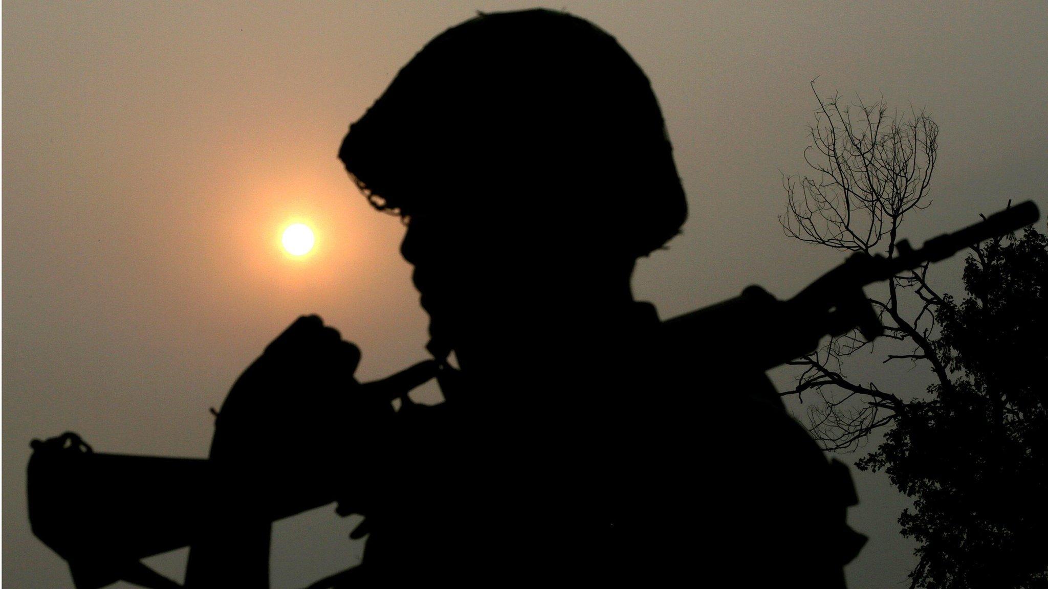 An Indian Border Security Force (BSF) soldier is silhouetted against the sun as he patrols about 60 km from Jammu on 26 September 2016.