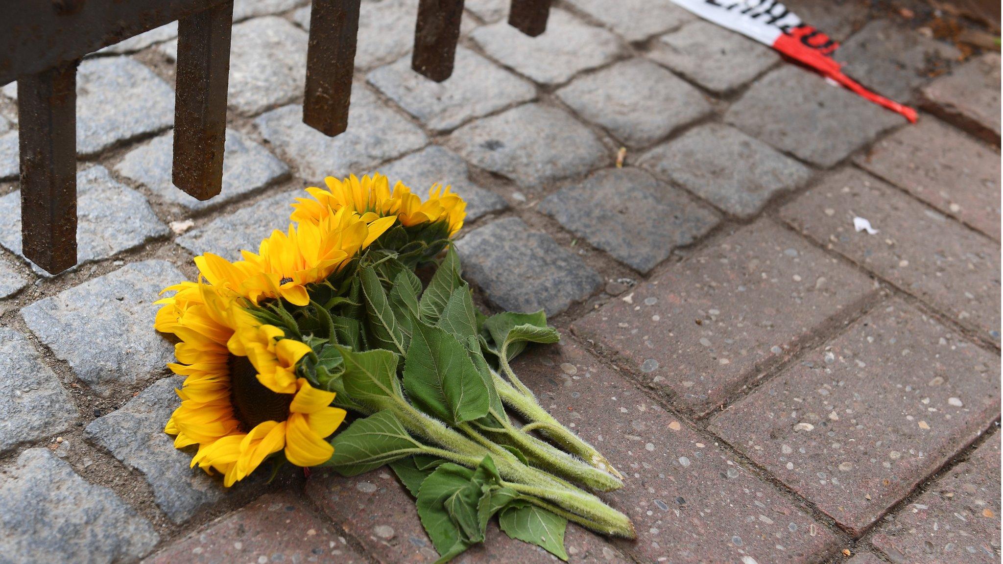 Flowers lie near the area of a suicide bomb attack at a music festival on July 25, 2016 in Ansbach, Germany.