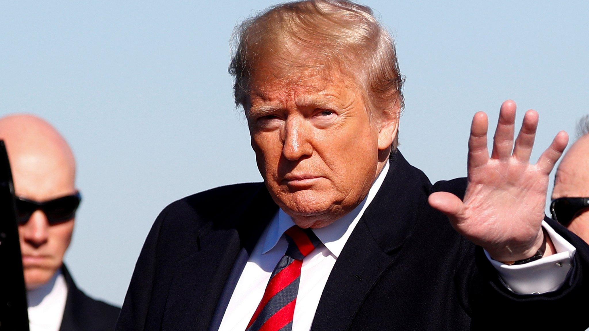 President Donald Trump waves to the press at Tuscaloosa Regional Airport in Tuscaloosa, Alabama, November 9, 2019