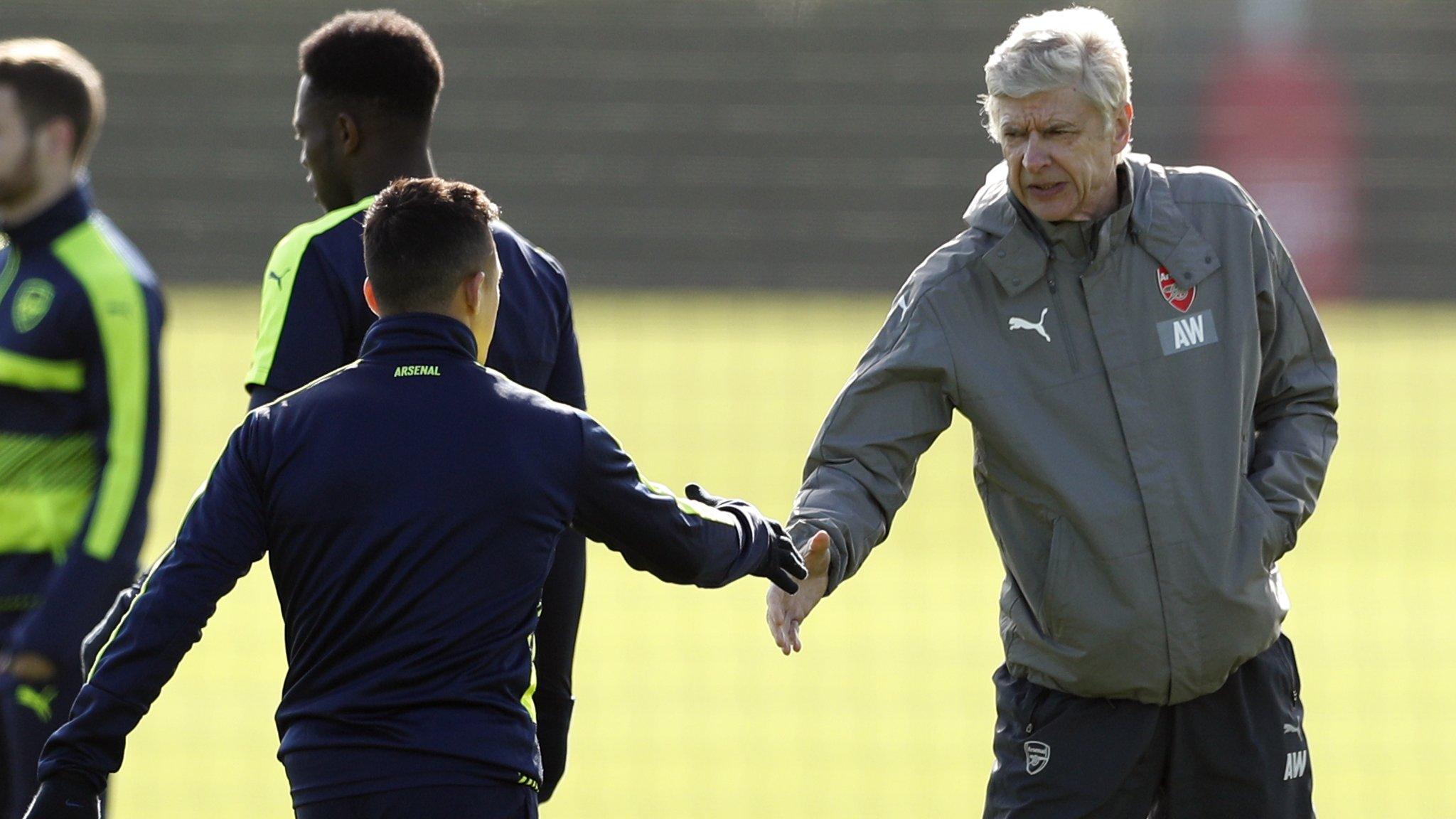 Arsenal manager Arsene Wenger (right) shakes hands with Alexis Sanchez at training