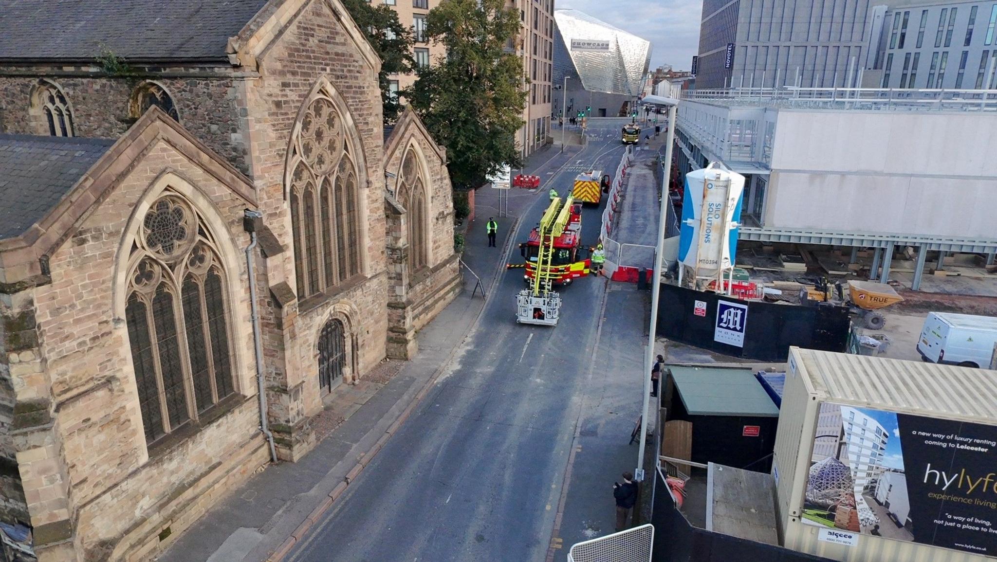 Aerial view of closed street next to church with fire engine and ladder visible