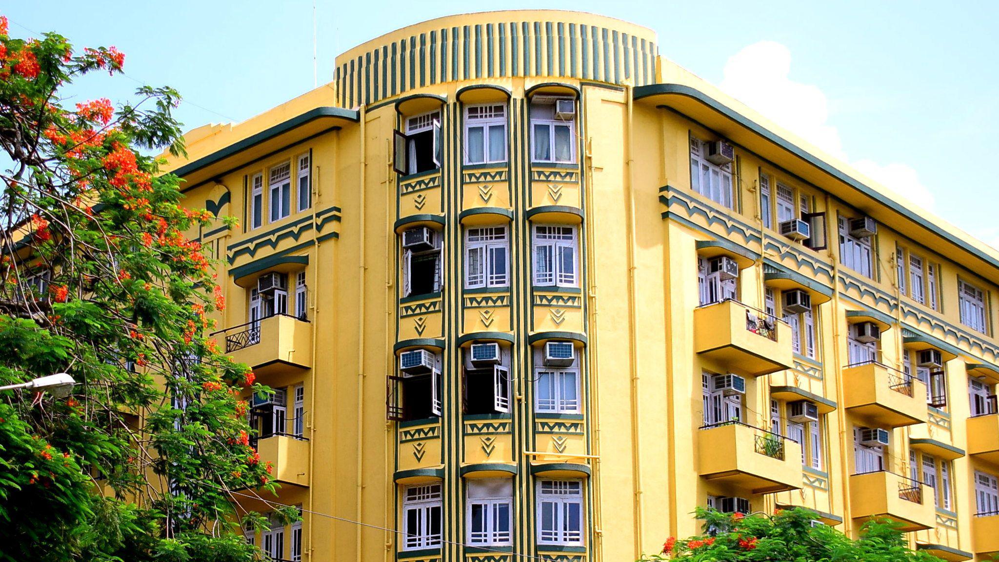 The butter-yellow, bottle-green, dual-toned facade of the multi-storey Shiv Shanti Bhuvan building at Mumbai's Oval Maidan.