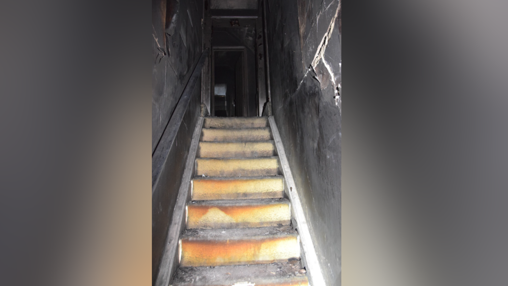 The stairs of the Chilworth home of Emma Wills after a fired caused by a modified e-bike. The stairs are ripped up and either side of the stair well is black. 