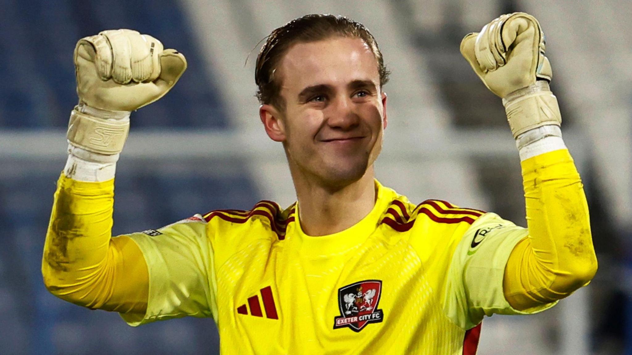 Joe Whitworth raises both arms in celebration