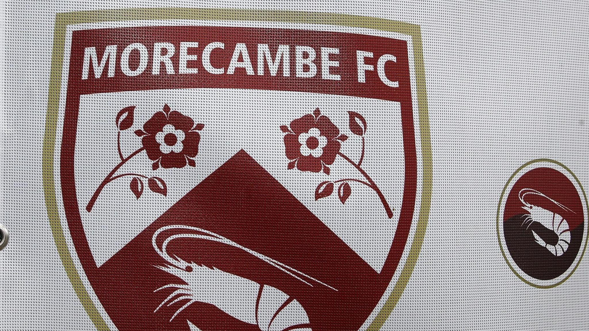 Morecambe's crest on a sign at their Mazuma Stadium home