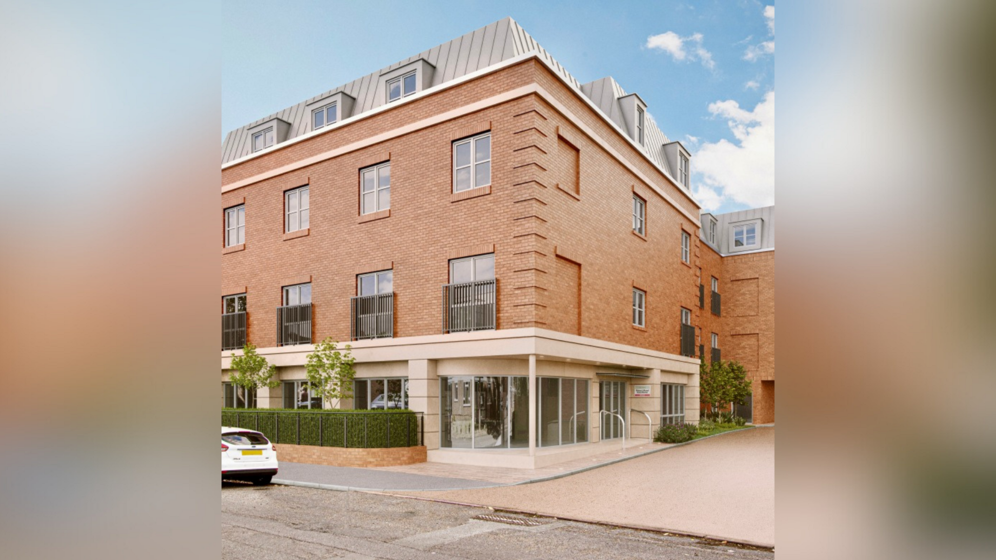 CGI of proposed care home, Princes Road, Weybridge. The red brick building has three stories and grey window frames. There are grey skylights on the top floor.