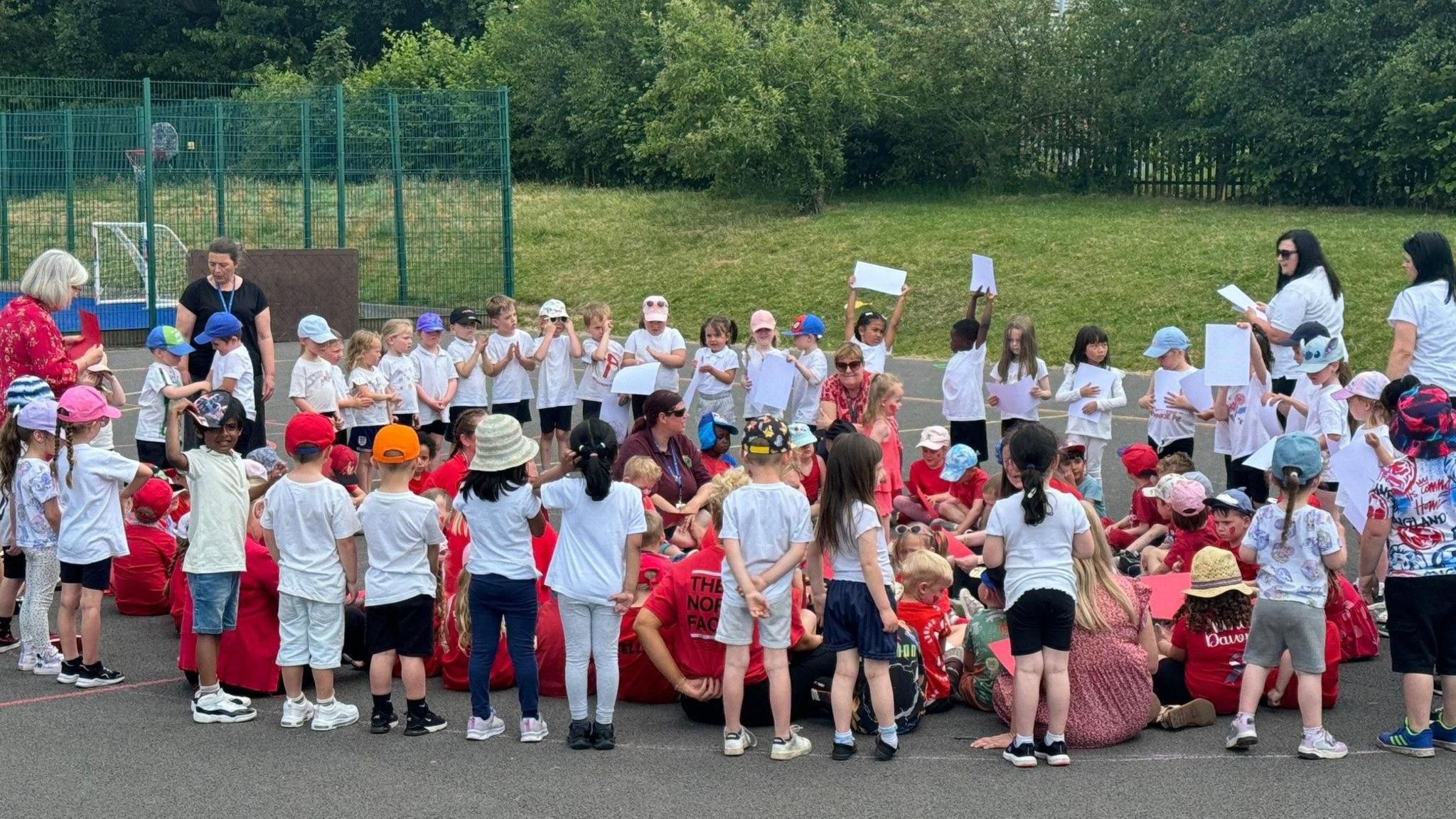 Children standing in the formation of a heart