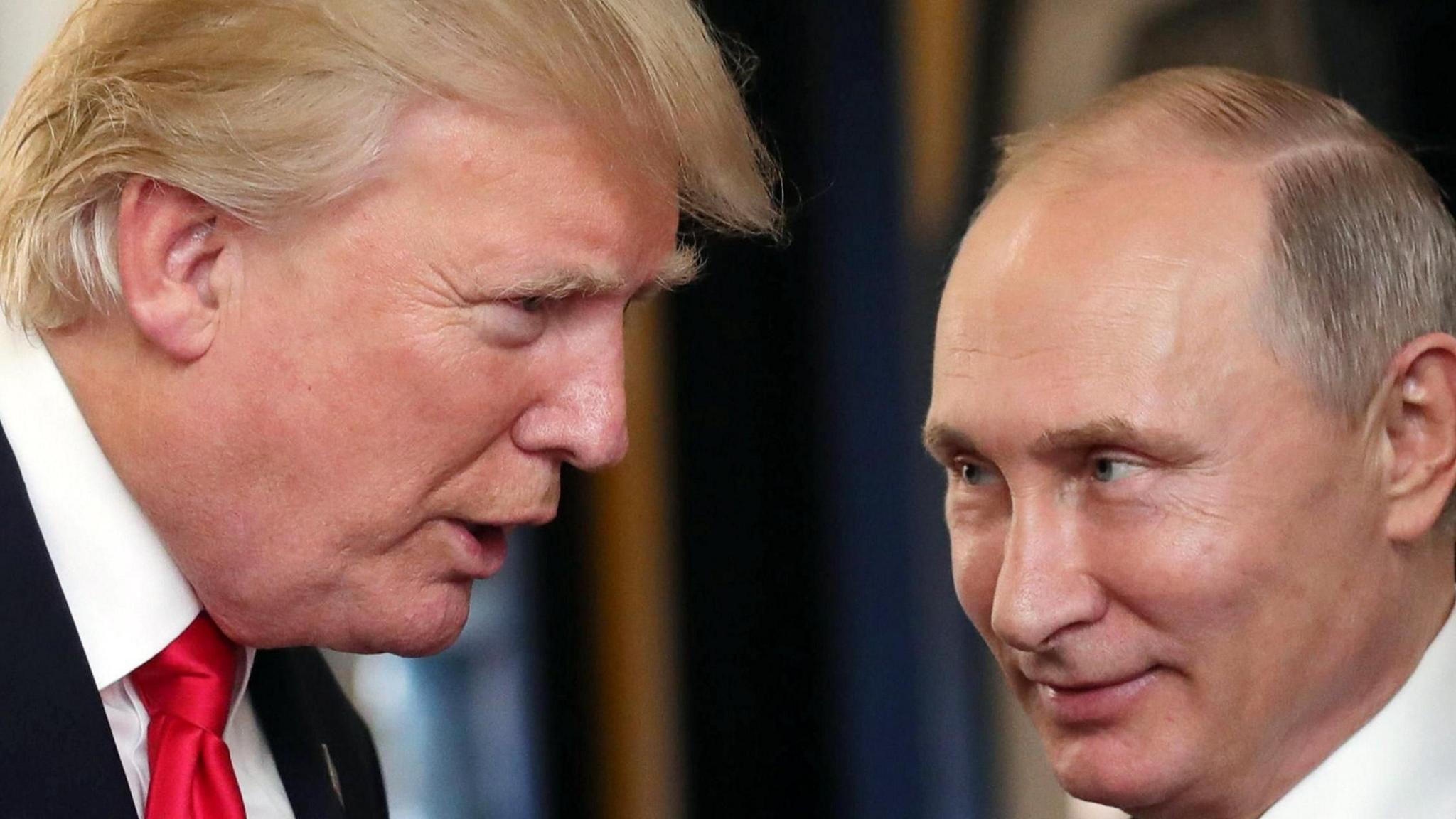 Donald Trump on the left hand side of the image leans towards Vladimir Putin on the right.