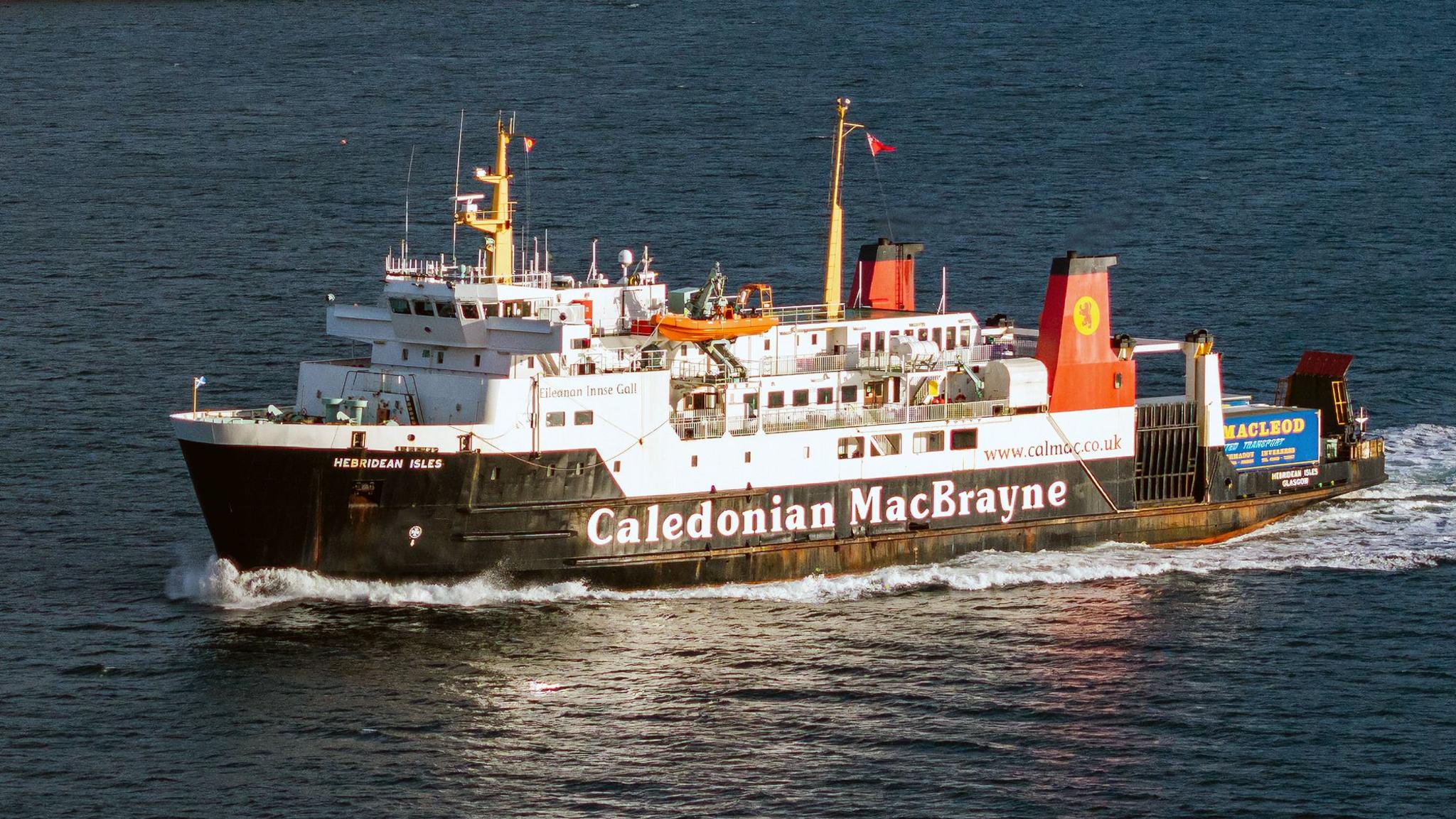 Hebridean Isles, a black and white ship with red funnels sailing with a wake of white water behind it