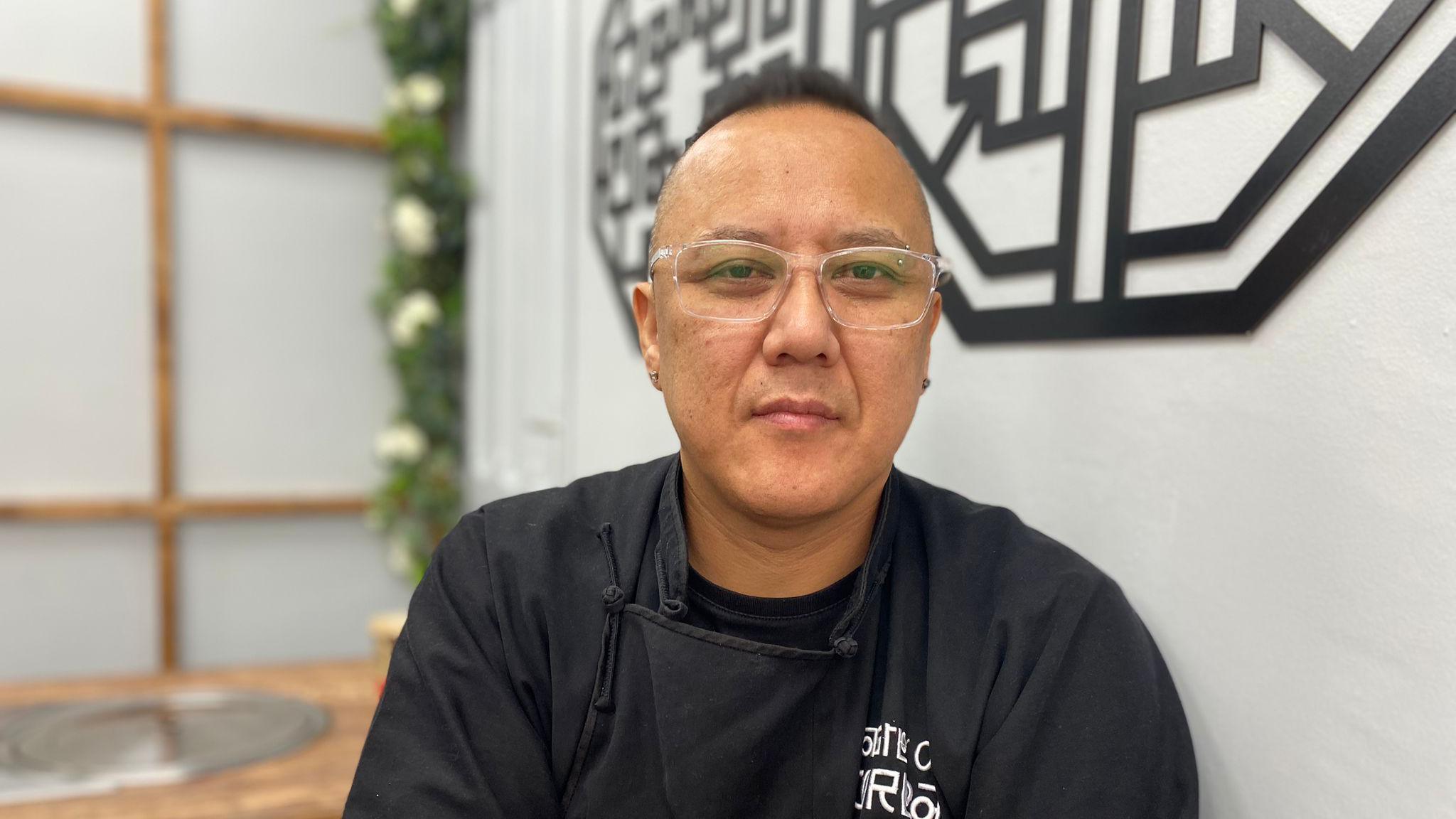 Restaurant owner Dima Kim is sitting in his restaurant A Taste of Korea, which is on Main Street in Kimberley