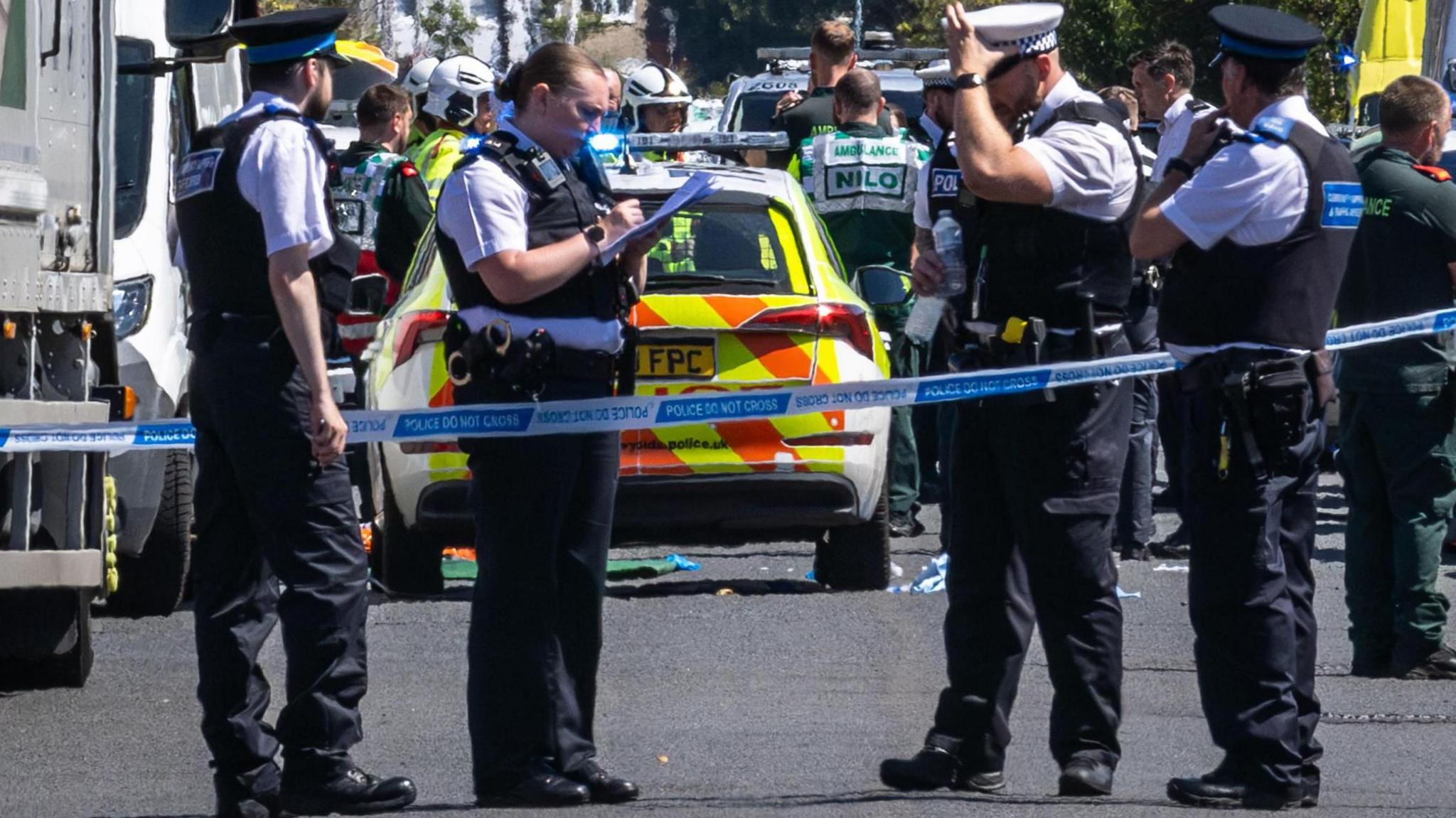 Police, fire and ambulance personnel gather in Southport following the fatal stabbing of three girls