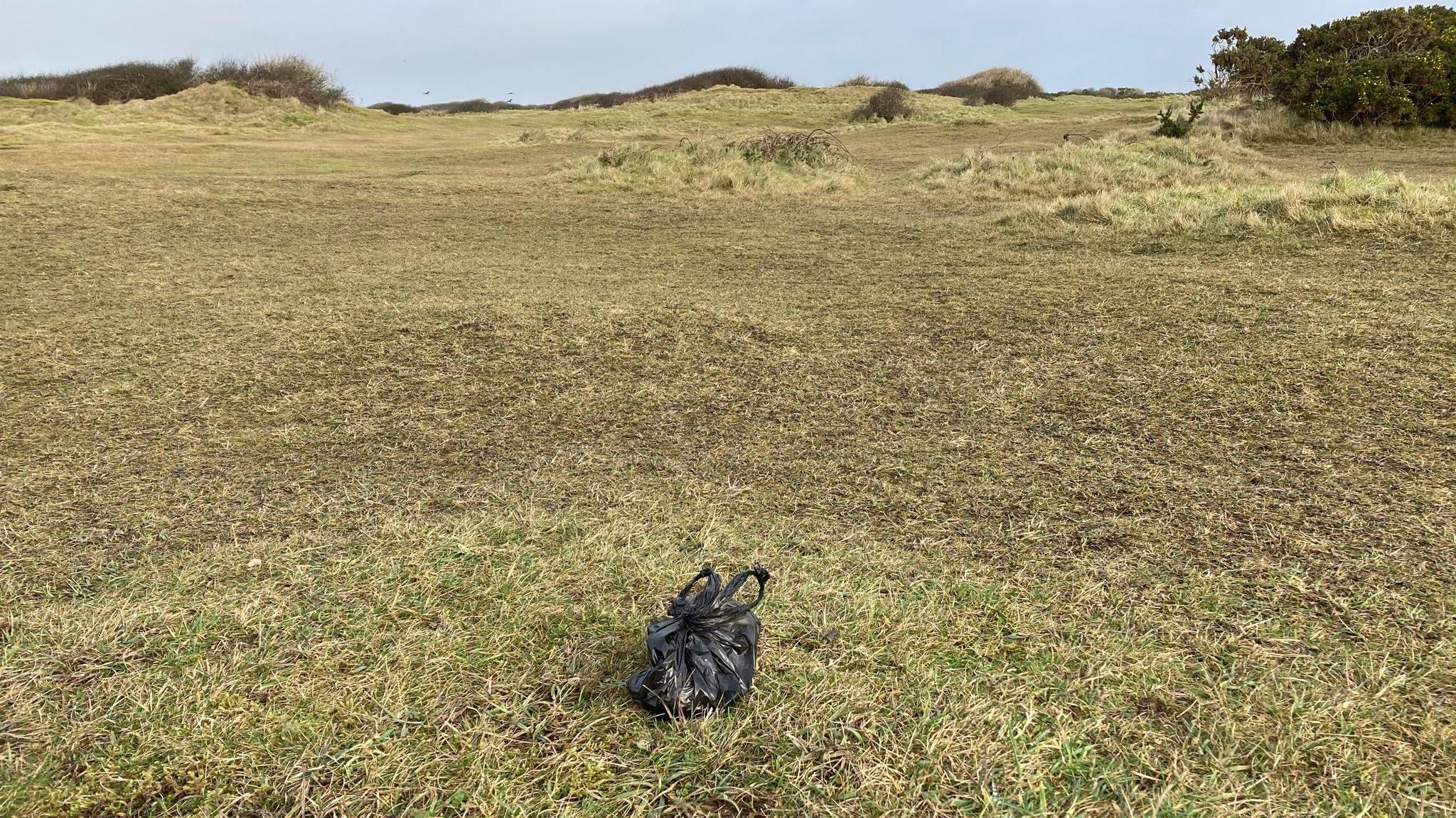 Penhale dunes with a small black plastic bag tied up