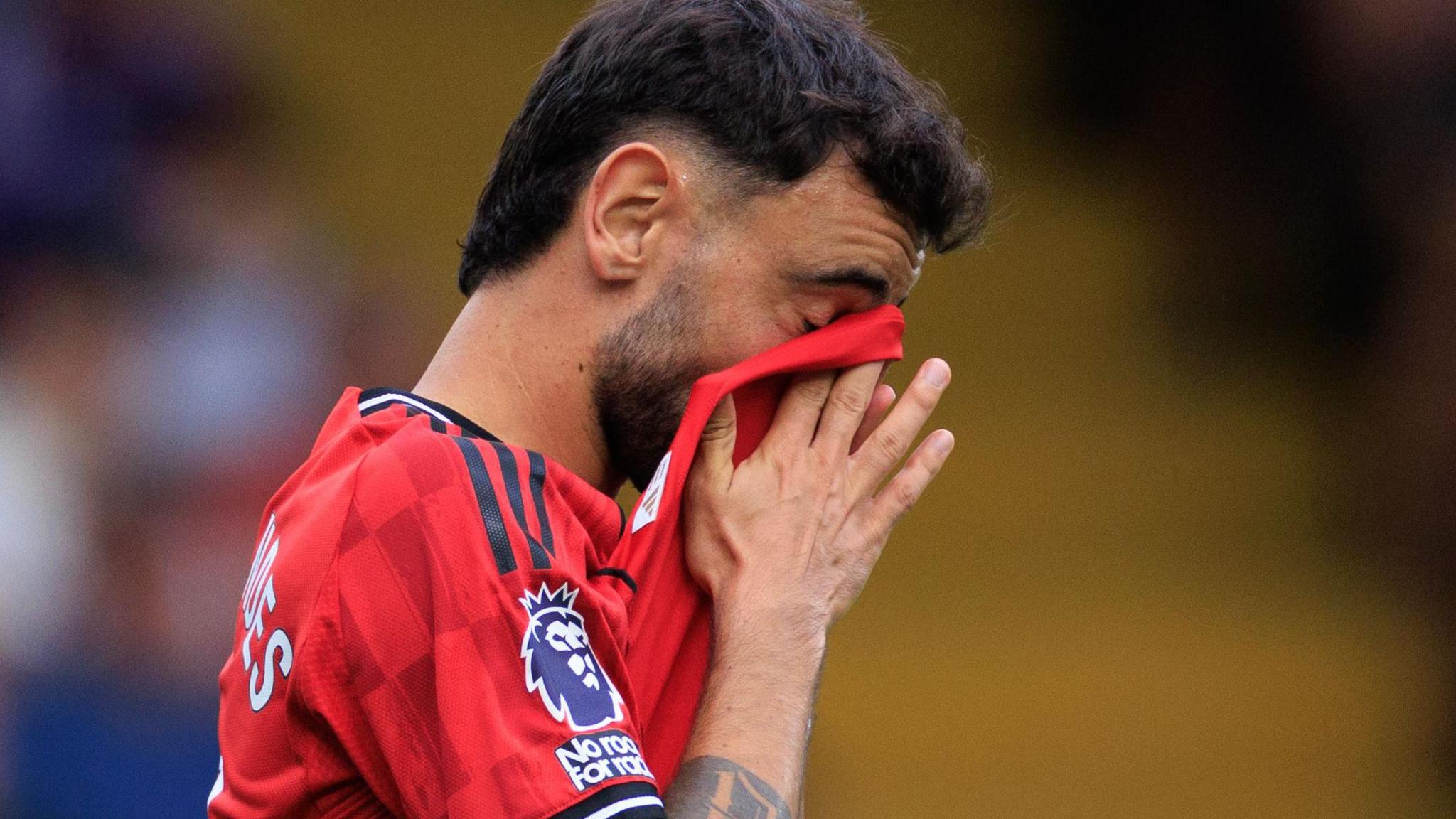 Manchester United captain Bruno Fernandes covers his face after missing a penalty against Fulham