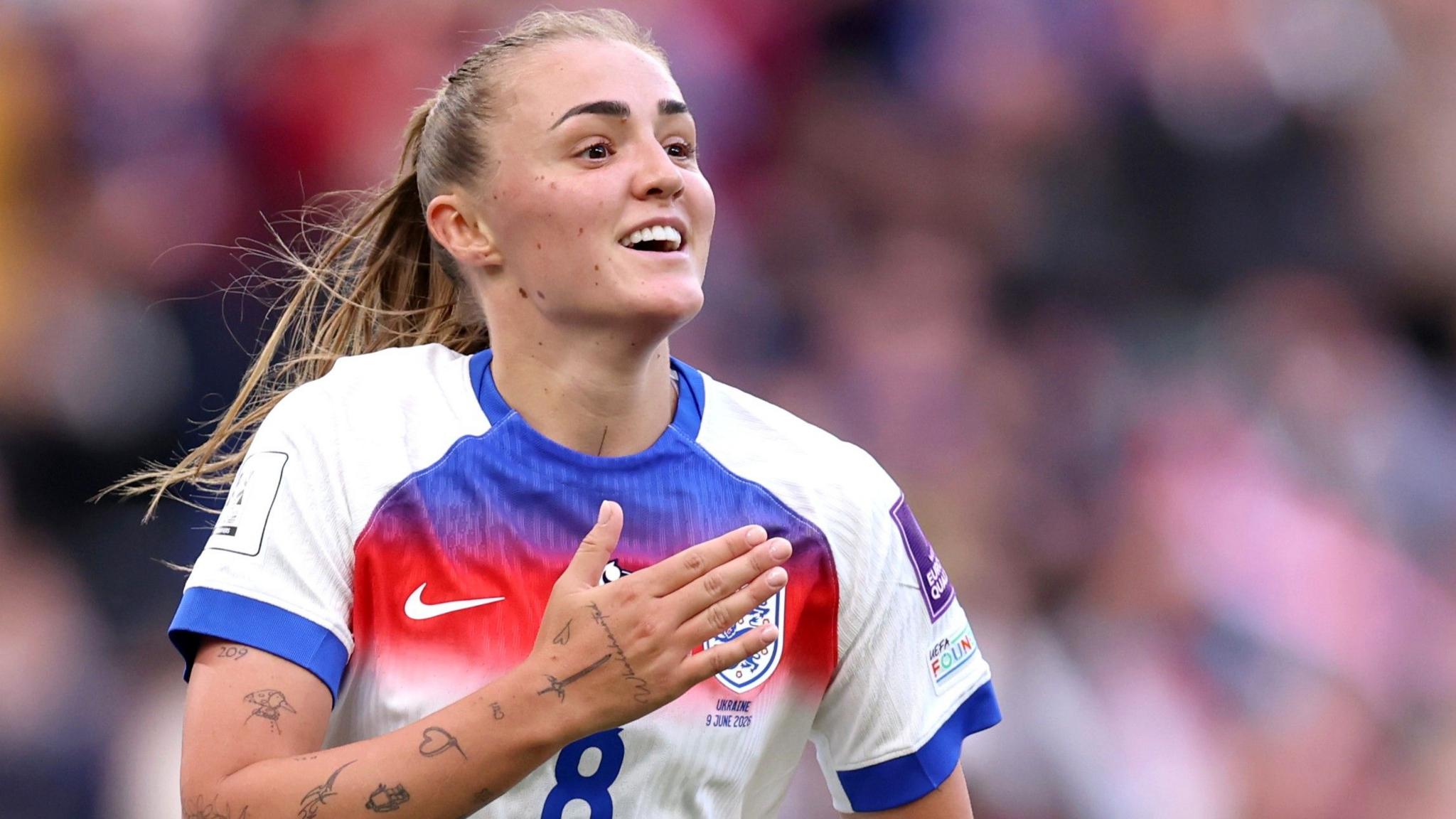 Georgia Stanway pats her chest in celebration