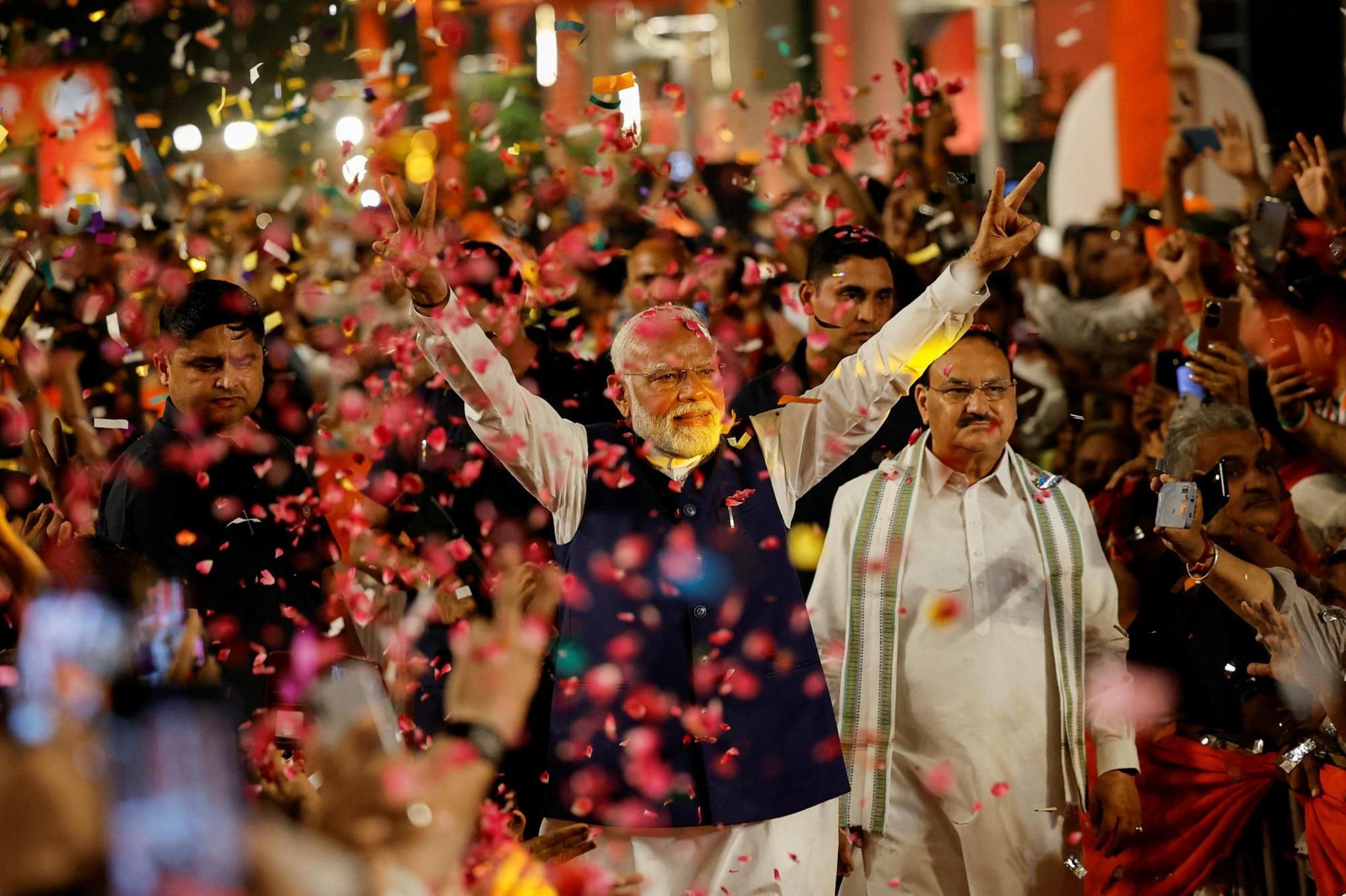 Supporters throw petals on Indian Prime Minister Narendra Modi 