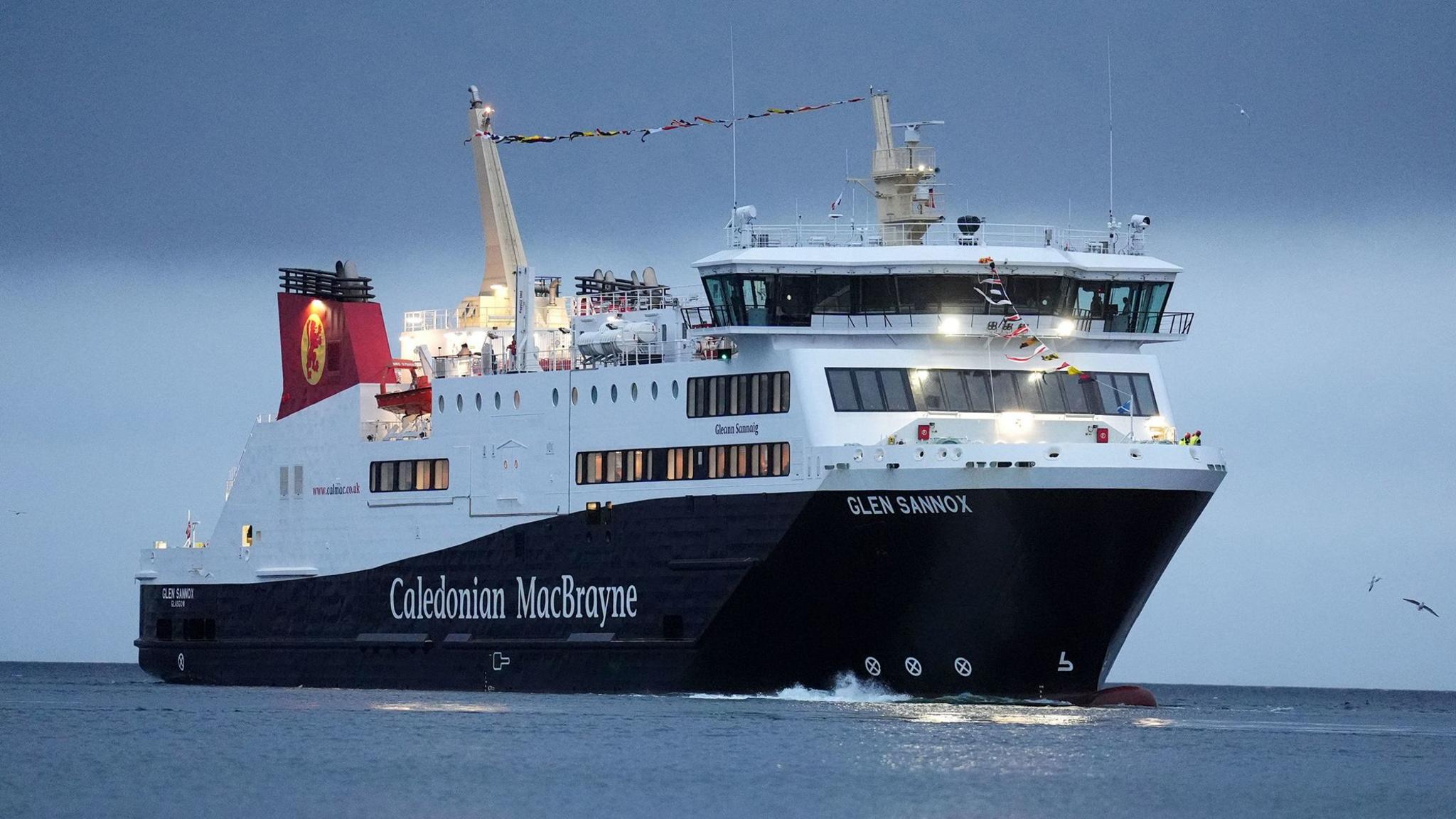 A large black and white ferry with red funnels and the words Caledonian MacBrayne written on the side