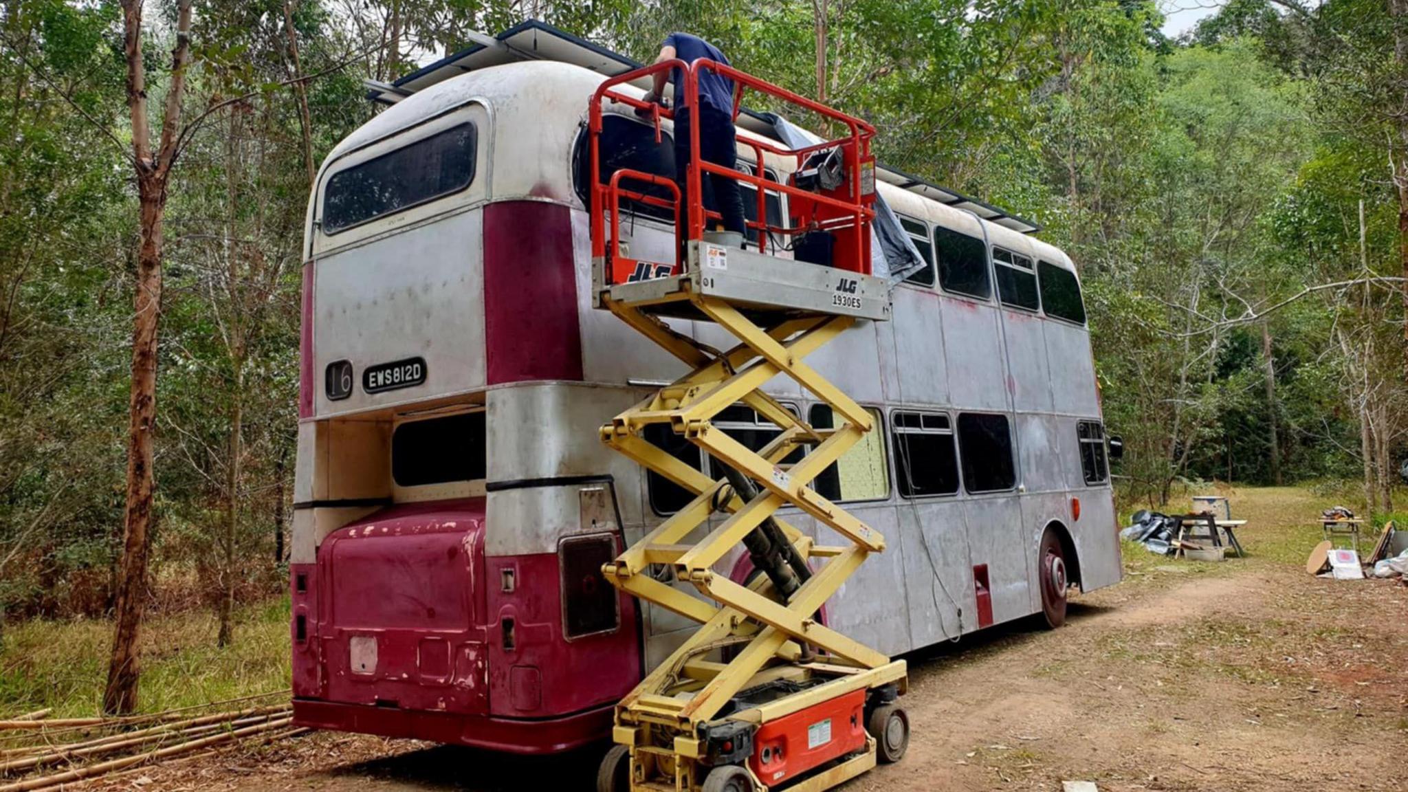 Ted restoring paintwork on the outside of the bus