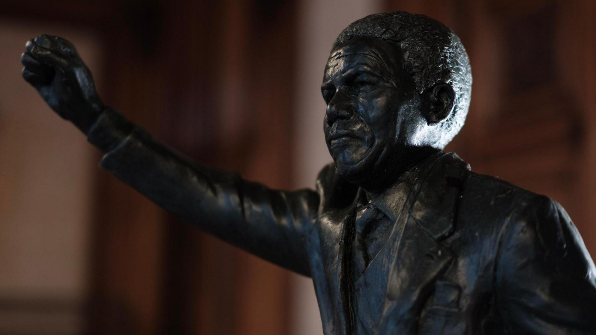 A proposed statue of Nelson Mandela. It has Mandela standing with one arm raised in the air