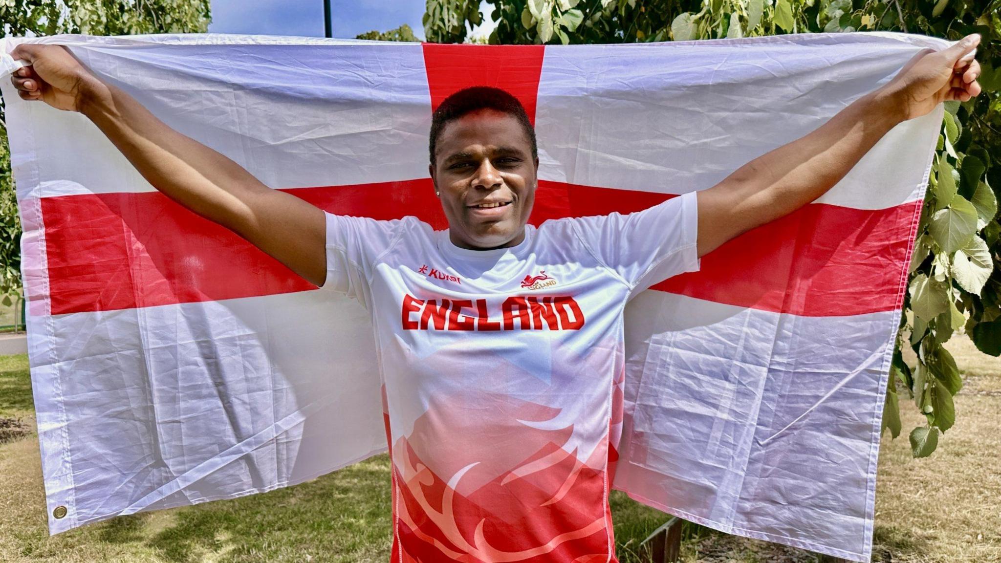 Madias Ngake holding an England flag