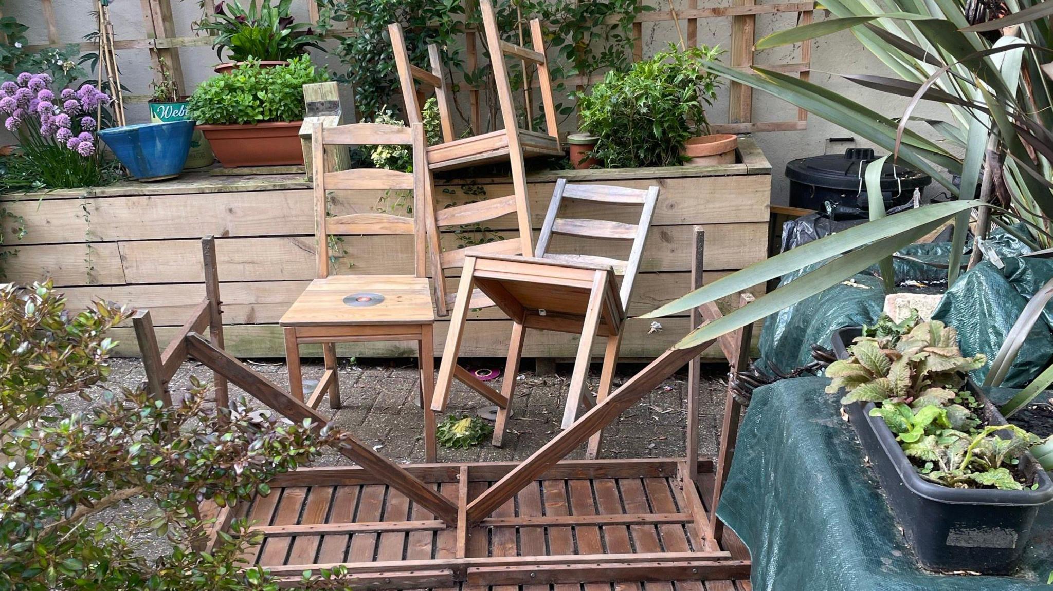 An overturned table and chairs strewn across the Waterloo Street Gardens in Hove